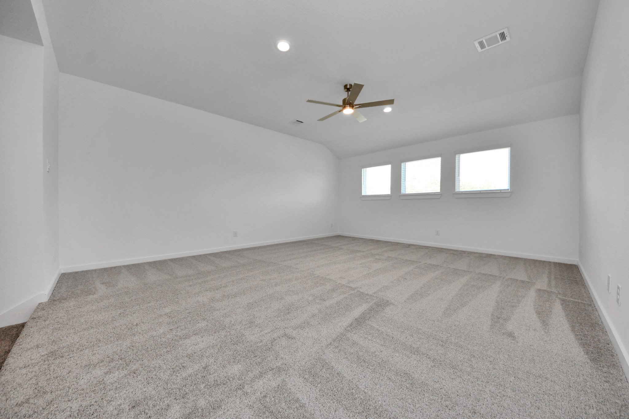 Come upstairs and enjoy a day of leisure in this fabulous game room! This is the perfect hangout spot or adult game room! Features plush carpet, high ceilings, custom paint and windows for plenty of natural light.