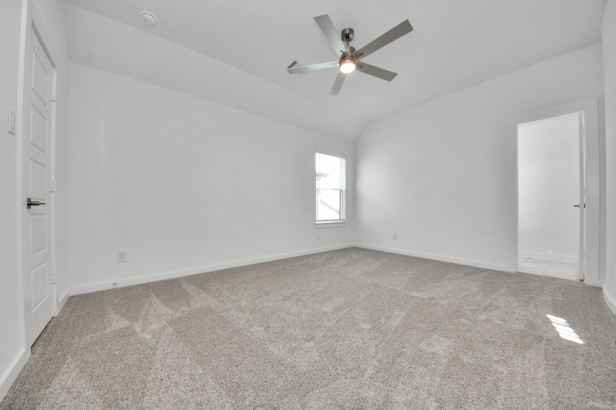 Secondary bedroom features plush carpeting, large windows that let in plenty of natural light, bright paint, and spacious closets.