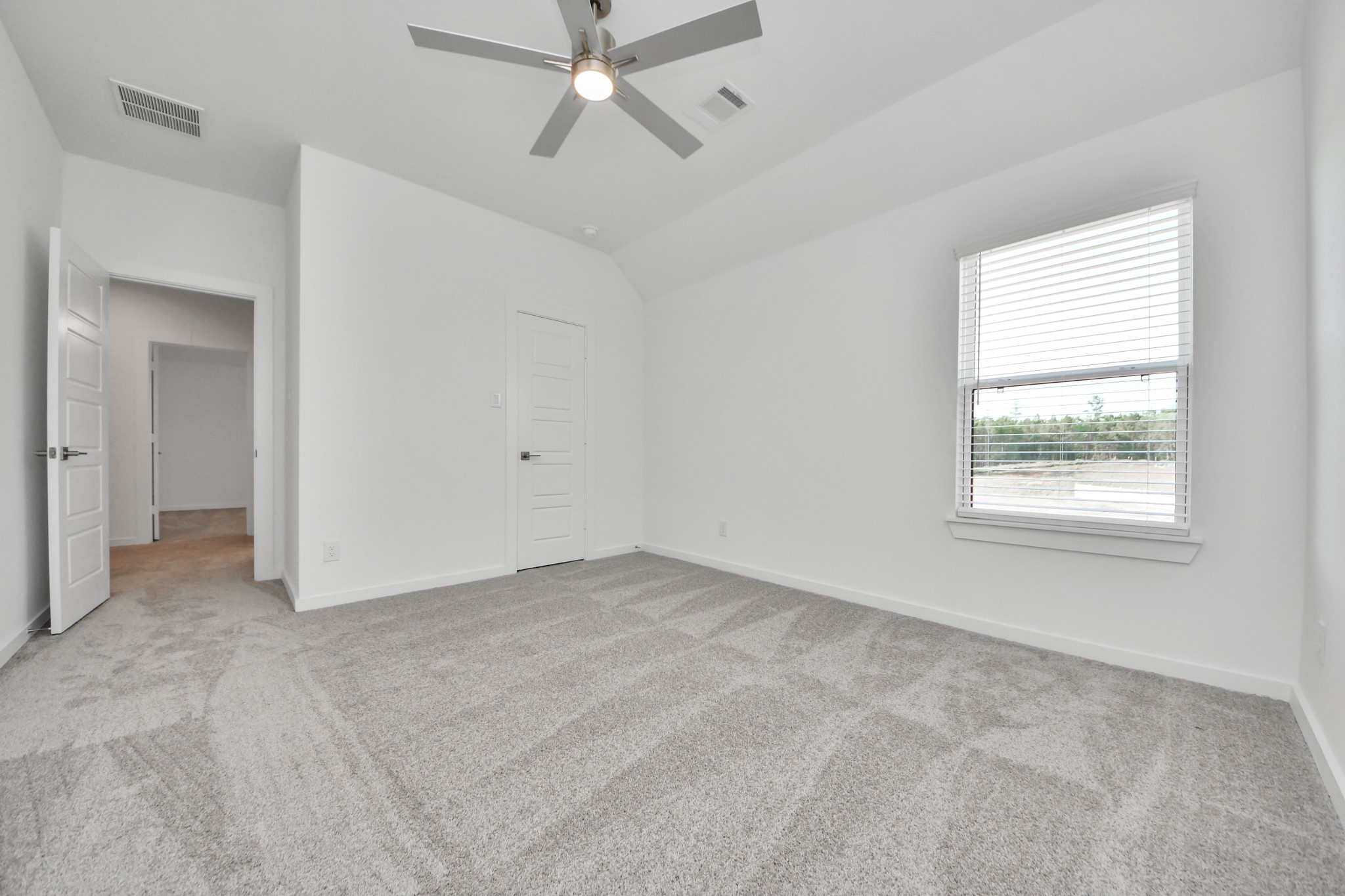 Generously sized secondary bedrooms featuring spacious closets, soft and inviting carpeting underfoot, large windows allowing plenty of natural light, and the added touch of privacy blinds for your personal retreat.