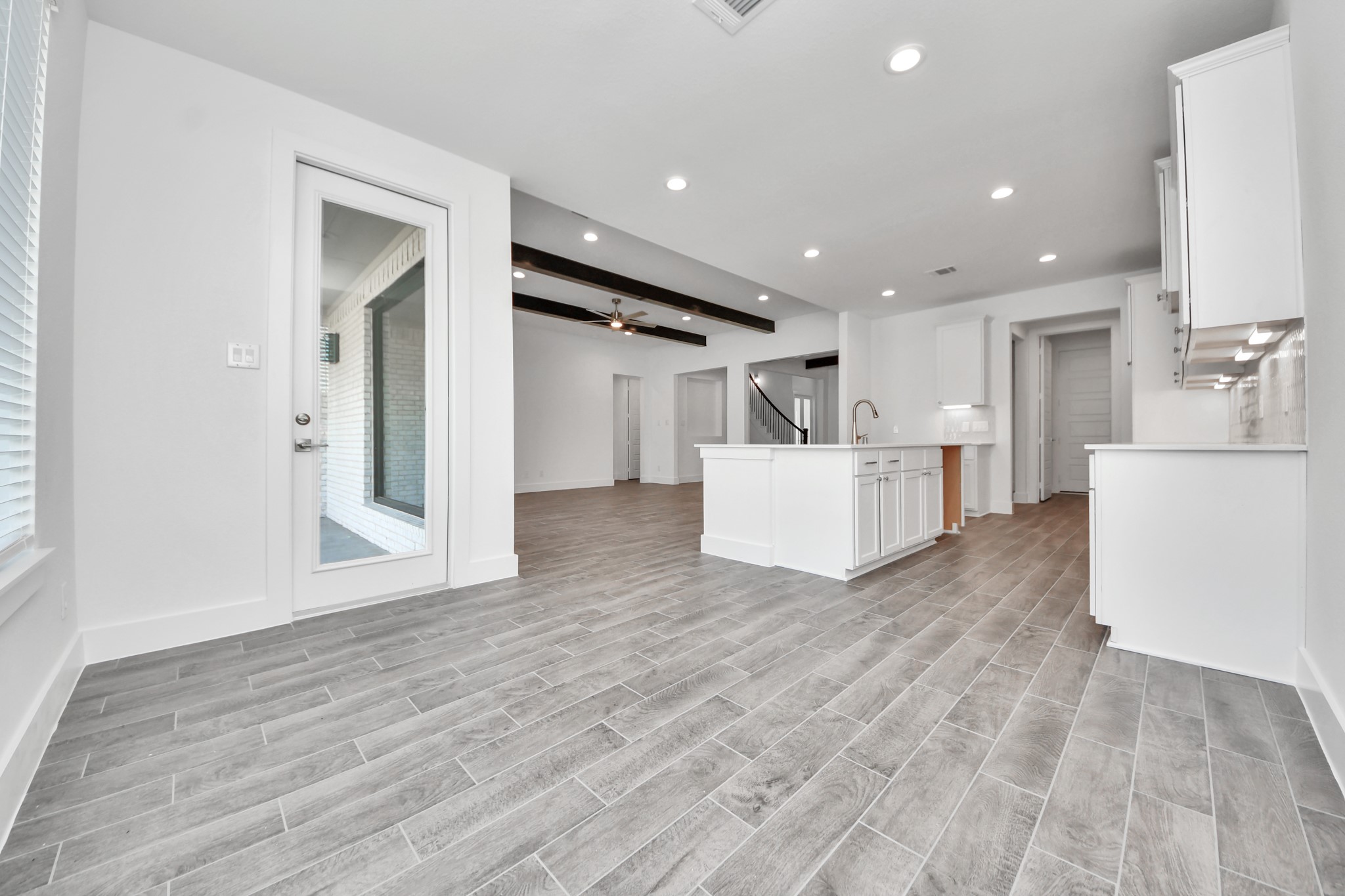 Enjoy breakfast with ease in the connected and cozy breakfast area, seamlessly integrated with the kitchen for utmost convenience. Step through the back door for a breath of fresh air onto the covered patio, extending your living space to the outdoors