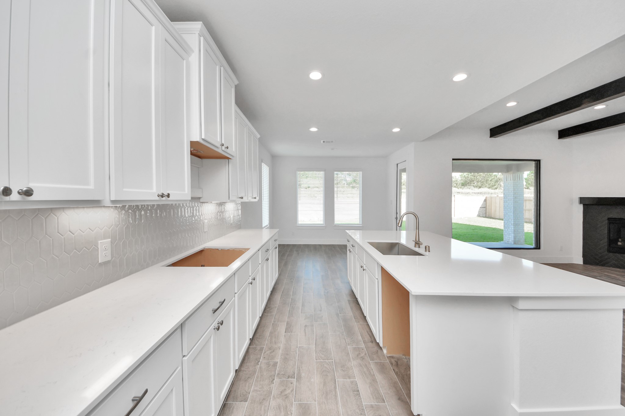 This kitchen is by far any chefs dream! This spacious kitchen features high ceilings, stained wood cabinets, granite countertop, SS appliances, modern tile backsplash, recessed lighting, extended counter space, granite kitchen island with double sink, and space for breakfast bar, and a walk-in pantry all overlooking your huge family room.