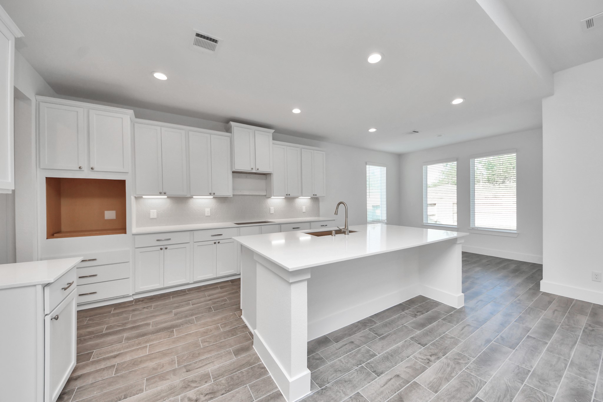 The kitchen is a culinary haven, featuring granite countertops, a tile backsplash, stainless steel appliances, 42 upper cabinets, and undercabinet lighting.