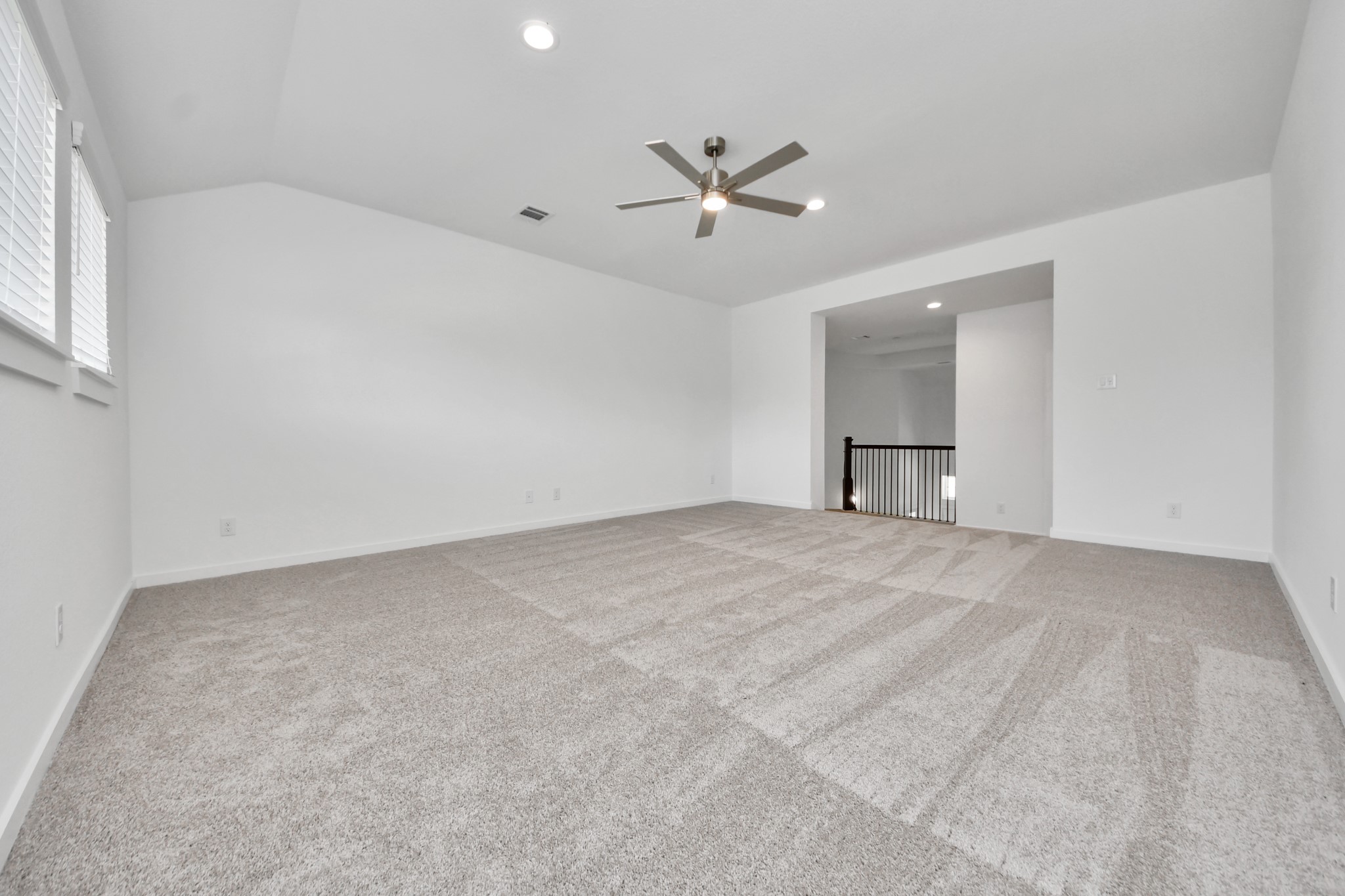 Ascend to relaxation in this fantastic game room! Ideal for both casual gatherings and adult gaming, it boasts plush carpet, lofty ceilings, custom paint, and ample windows for abundant natural light