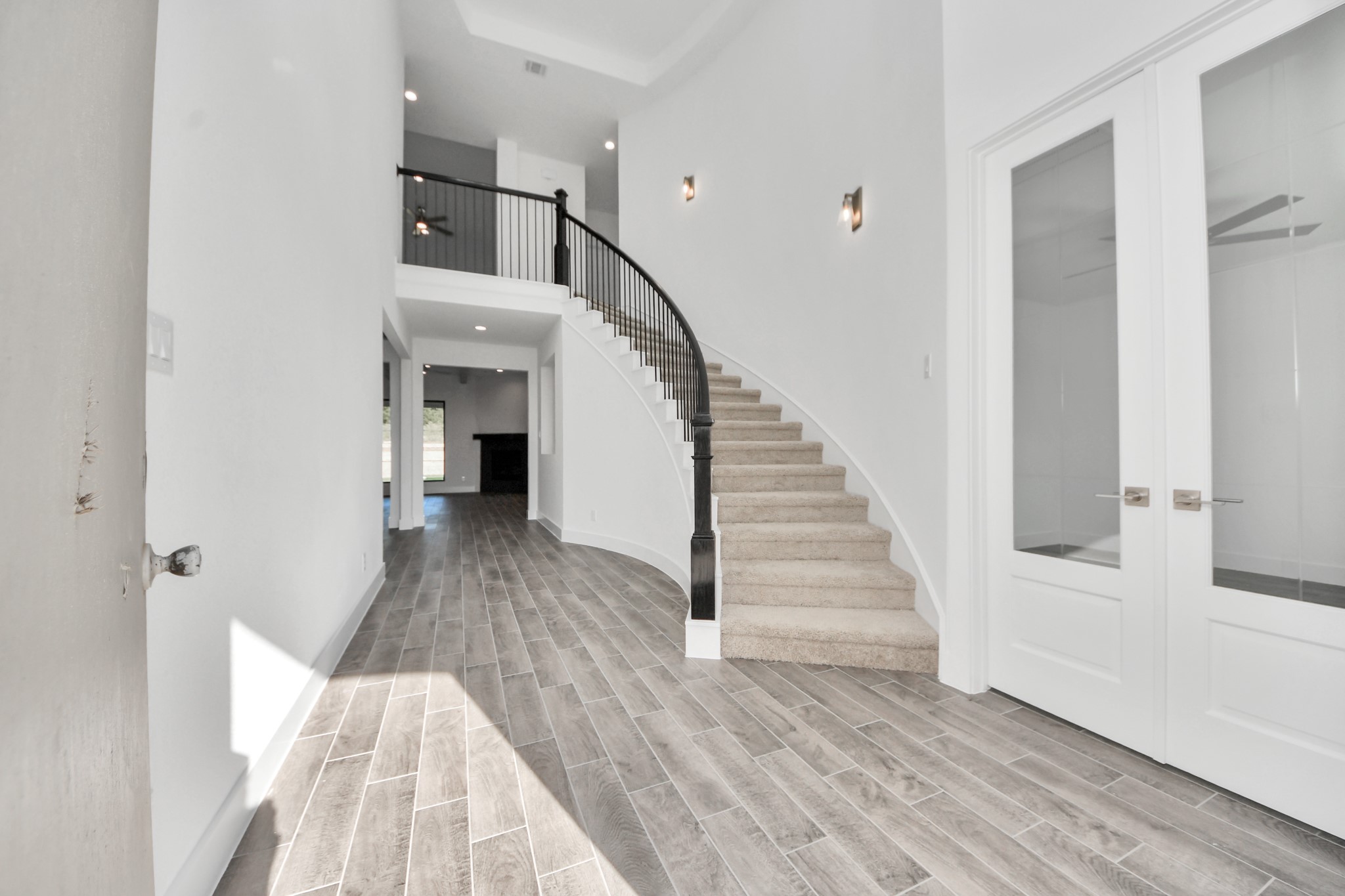 As you step into the threshold of this luxurious home, you'll soon be welcomed by an elegant glass door (to be installed). Inside, soaring ceilings amplify the spaciousness, while the refined wood-look tile flooring and oversized baseboards exude sophistication and charm. As you step into the threshold of this luxurious home, you'll soon be welcomed by an elegant glass door (to be installed). Inside, soaring ceilings amplify the spaciousness, while the refined wood-look tile flooring and oversized baseboards exude sophistication and charm.
