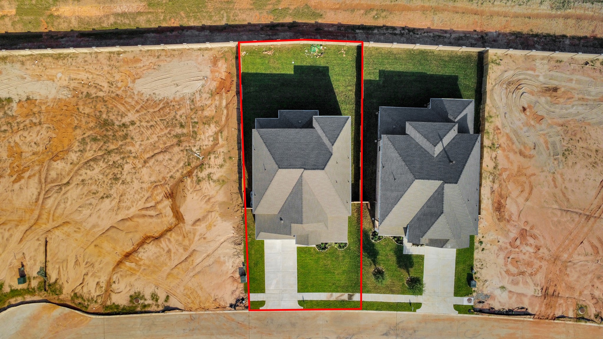 An aerial view of a spacious subdivision lot, highlighting a well-maintained yard and a fully fenced perimeter, offering both privacy and expansive outdoor space. An aerial view of a spacious subdivision lot, highlighting a well-maintained yard and a fully fenced perimeter, offering both privacy and expansive outdoor space.