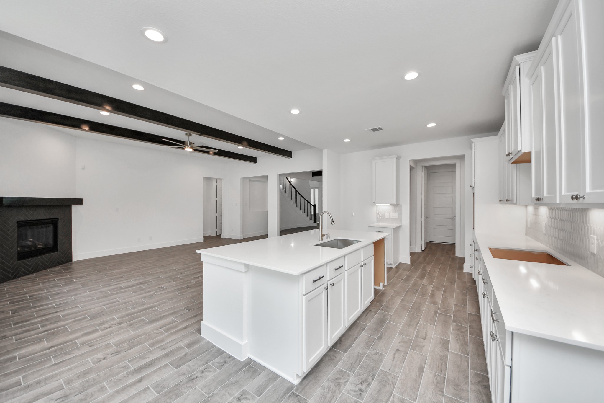 The open concept effortlessly connects the kitchen to the expansive family room, forming a perfect hub for gatherings. This seamless flow creates an inviting space where cooking and socializing come together harmoniously.