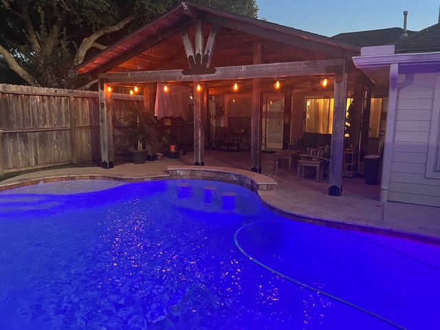 The pool sparkles at nighttime.
