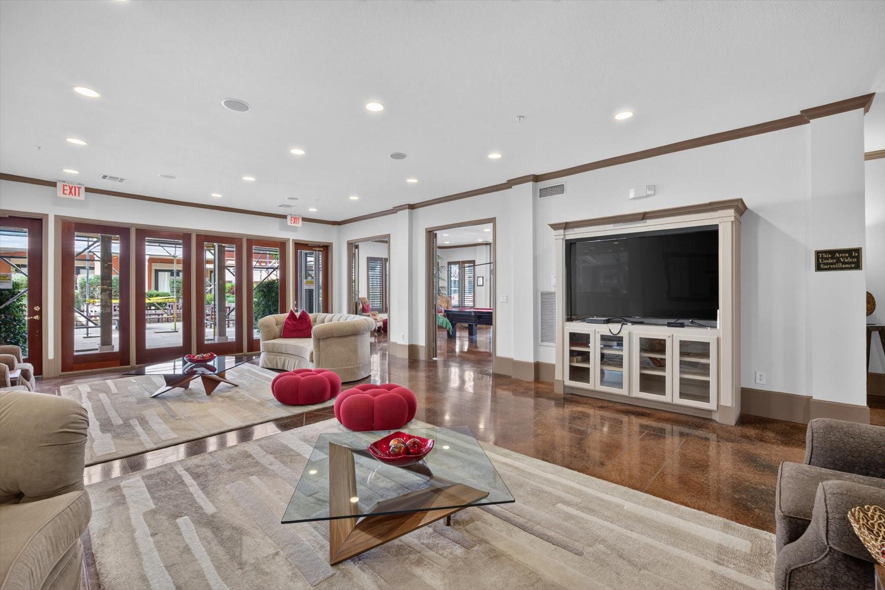 Residents can use the clubhouse with elegant living area featuring polished floors, large windows for natural light, and a modern entertainment center, perfect for relaxation and social gatherings.