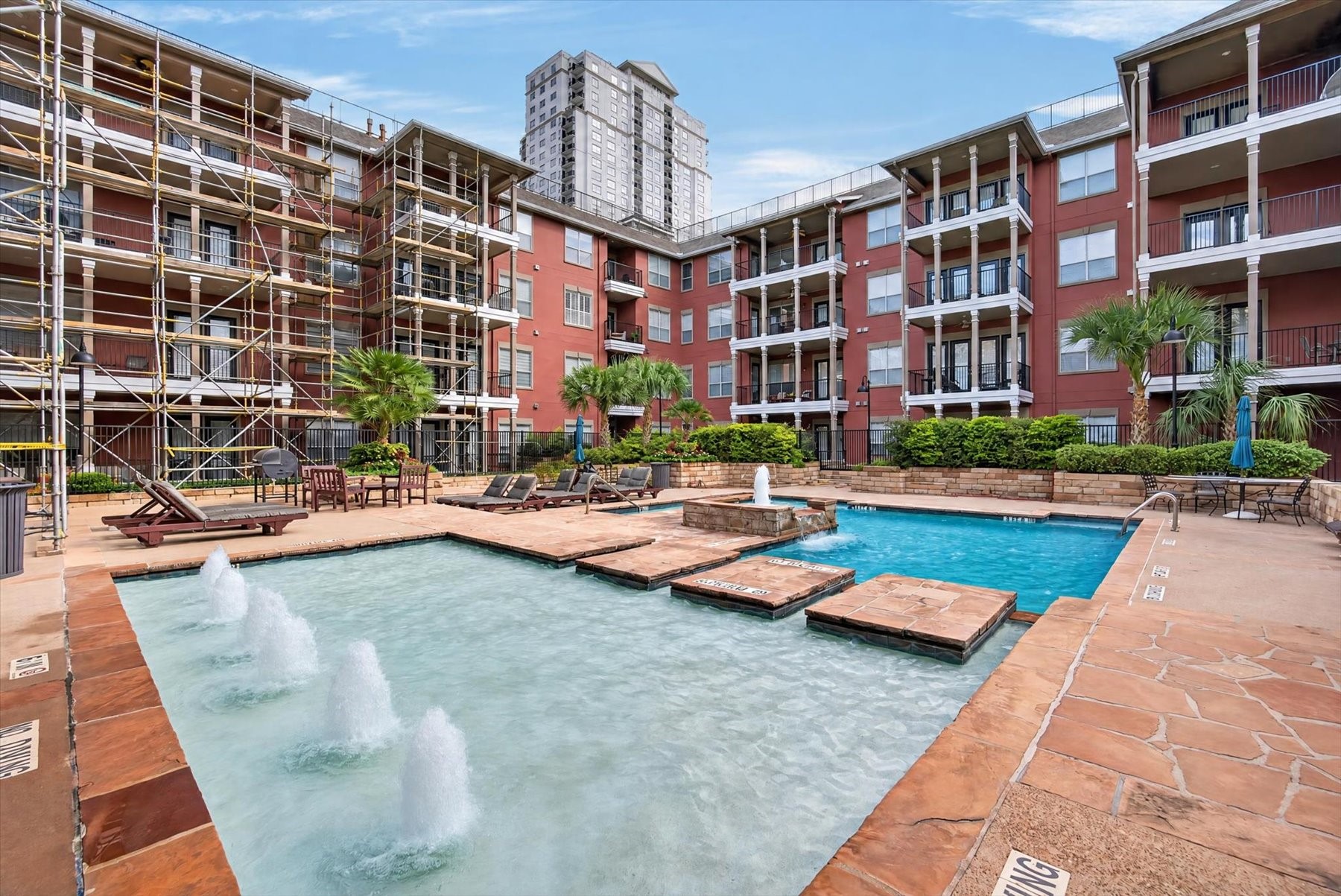 Experience resort-style living with this stunning pool area, featuring multiple water features and ample lounging space, perfect for relaxation and entertaining.