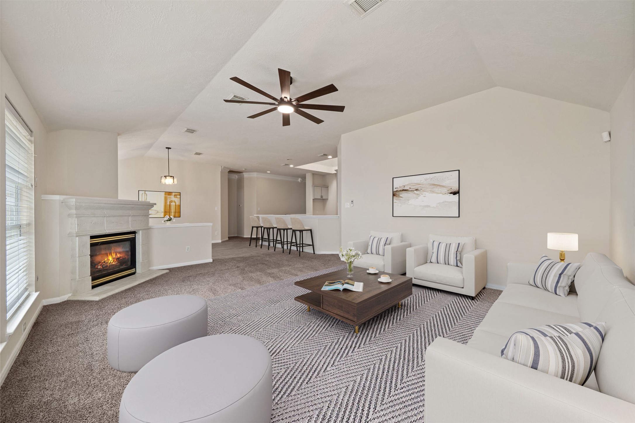 Spacious and inviting den features a stone gas fireplace, modern ceiling fan, and seamless transition to an open dining space, perfect for entertaining. *virtually staged