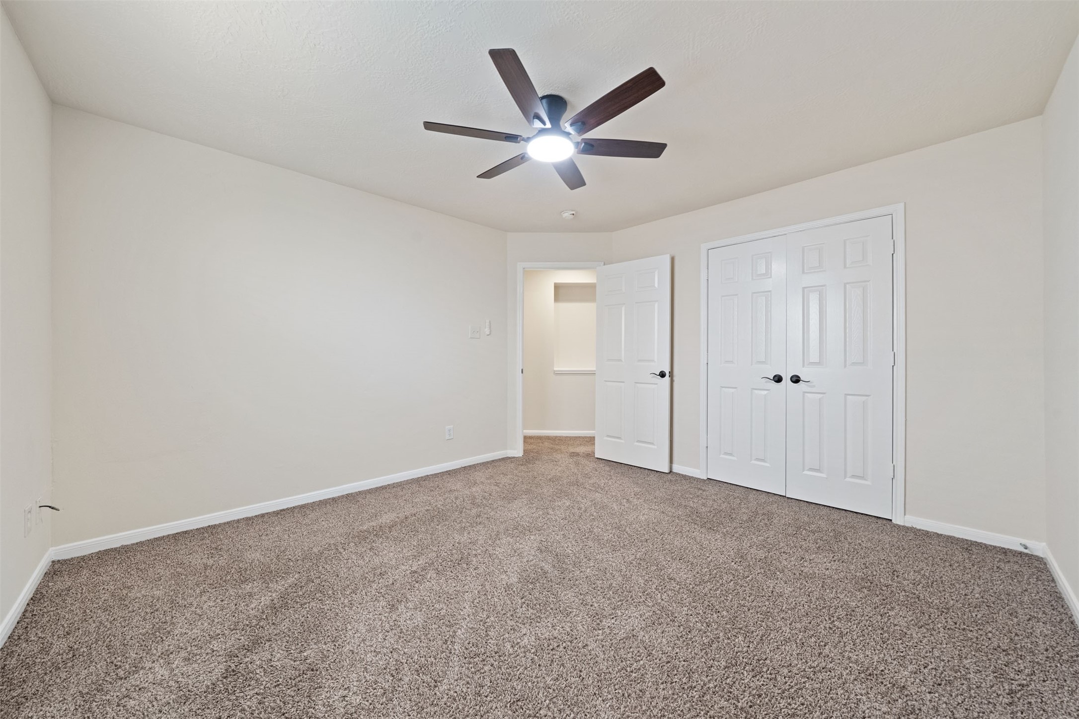 Also features plush carpet, neutral walls, and a closet space with double doors
