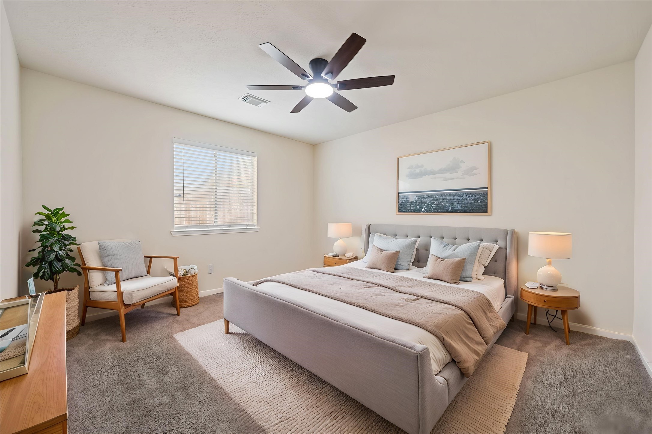 One of the secondary bedrooms with carpet, a modern ceiling fan, and natural light *virtually staged