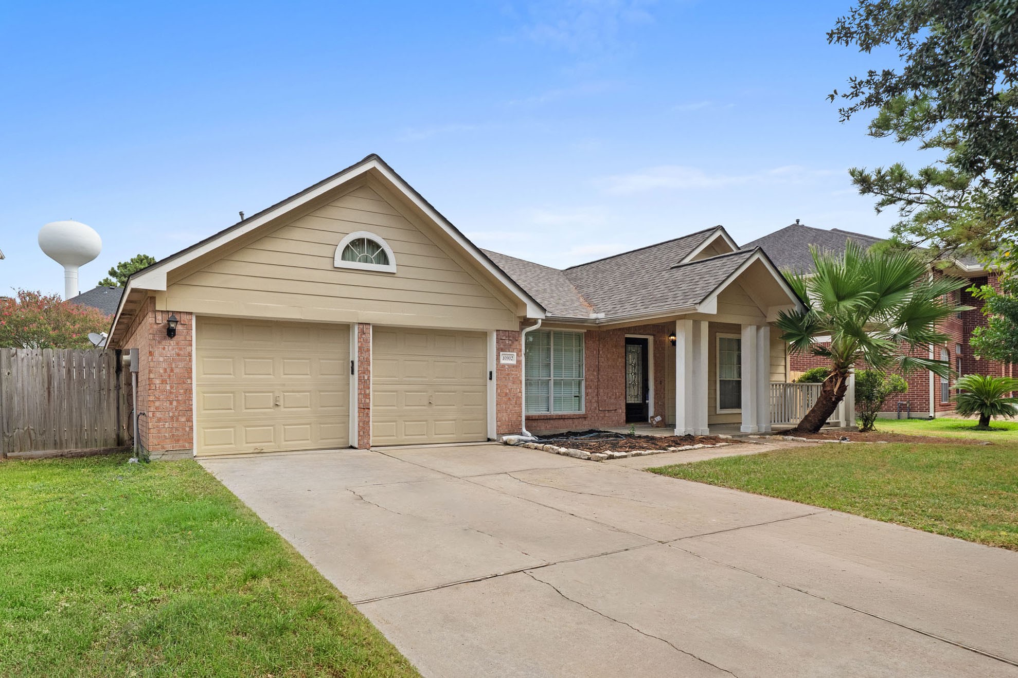 Charming single-story curb appeal with a welcoming front porch and two-car garage with new auto garage openers and epoxy flooring