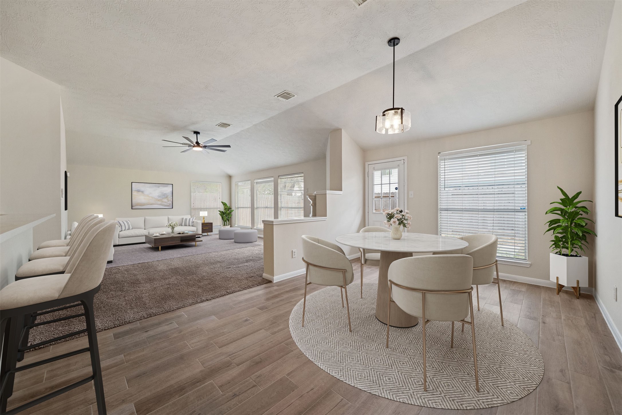 Bright breakfast area showcasing a new light fixture and ample natural light. *virtually staged