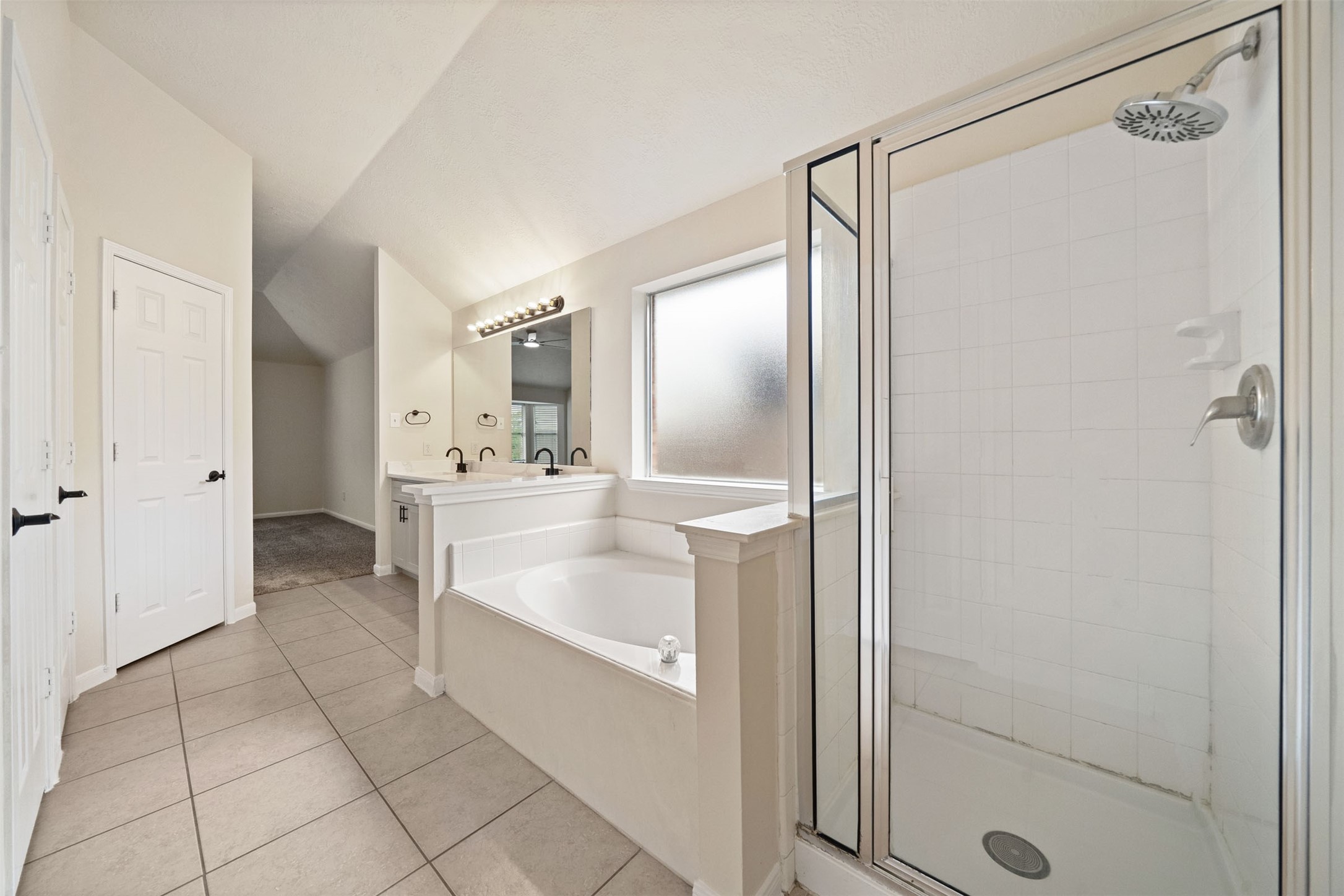 Featuring a luxurious soaking tub and separate glass-enclosed shower
