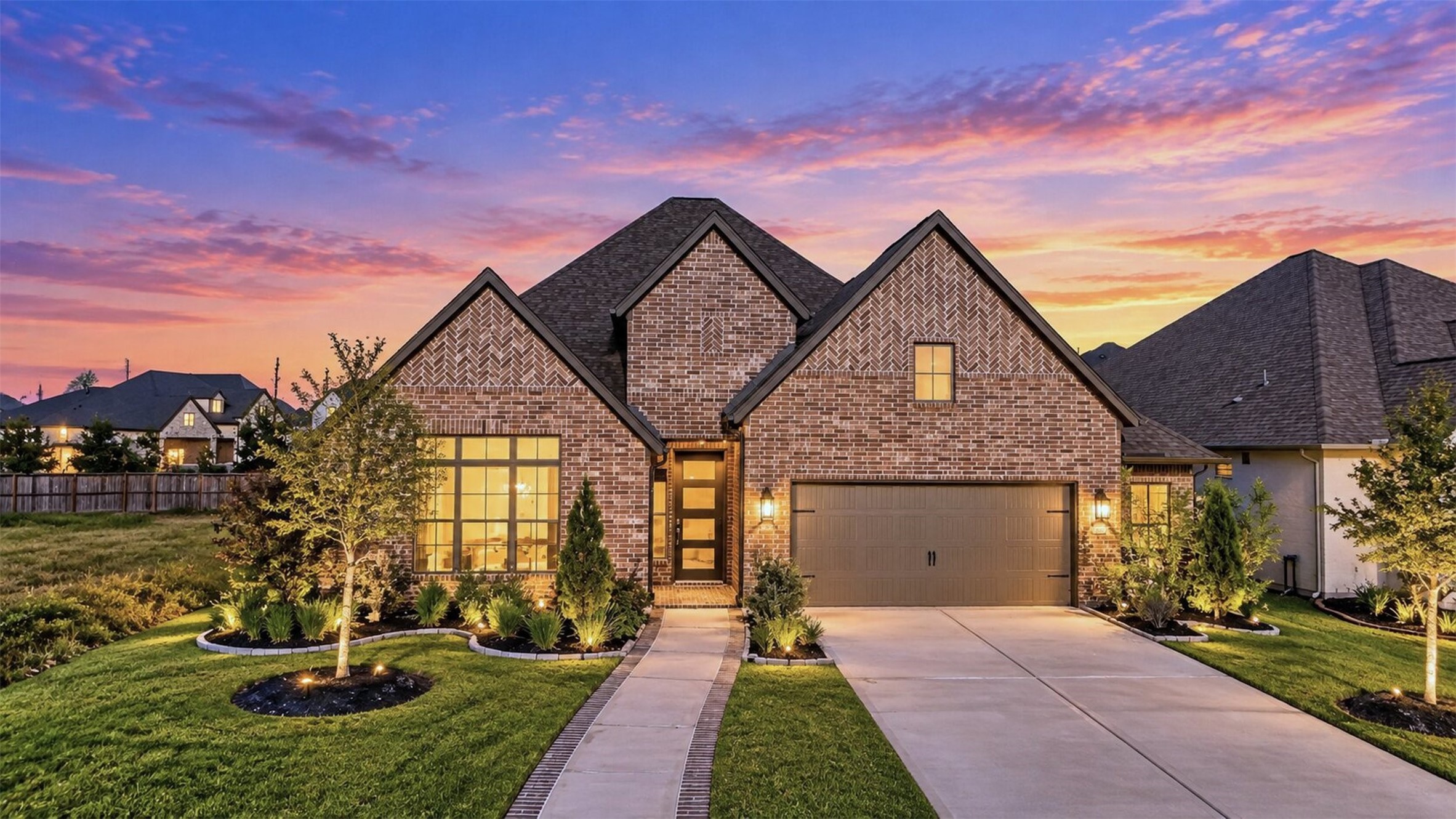 Front Exterior  Twilight: Beautiful brick exterior with distinctive architectural detailing, manicured landscaping, and warm exterior lighting that showcases the home's curb appeal.