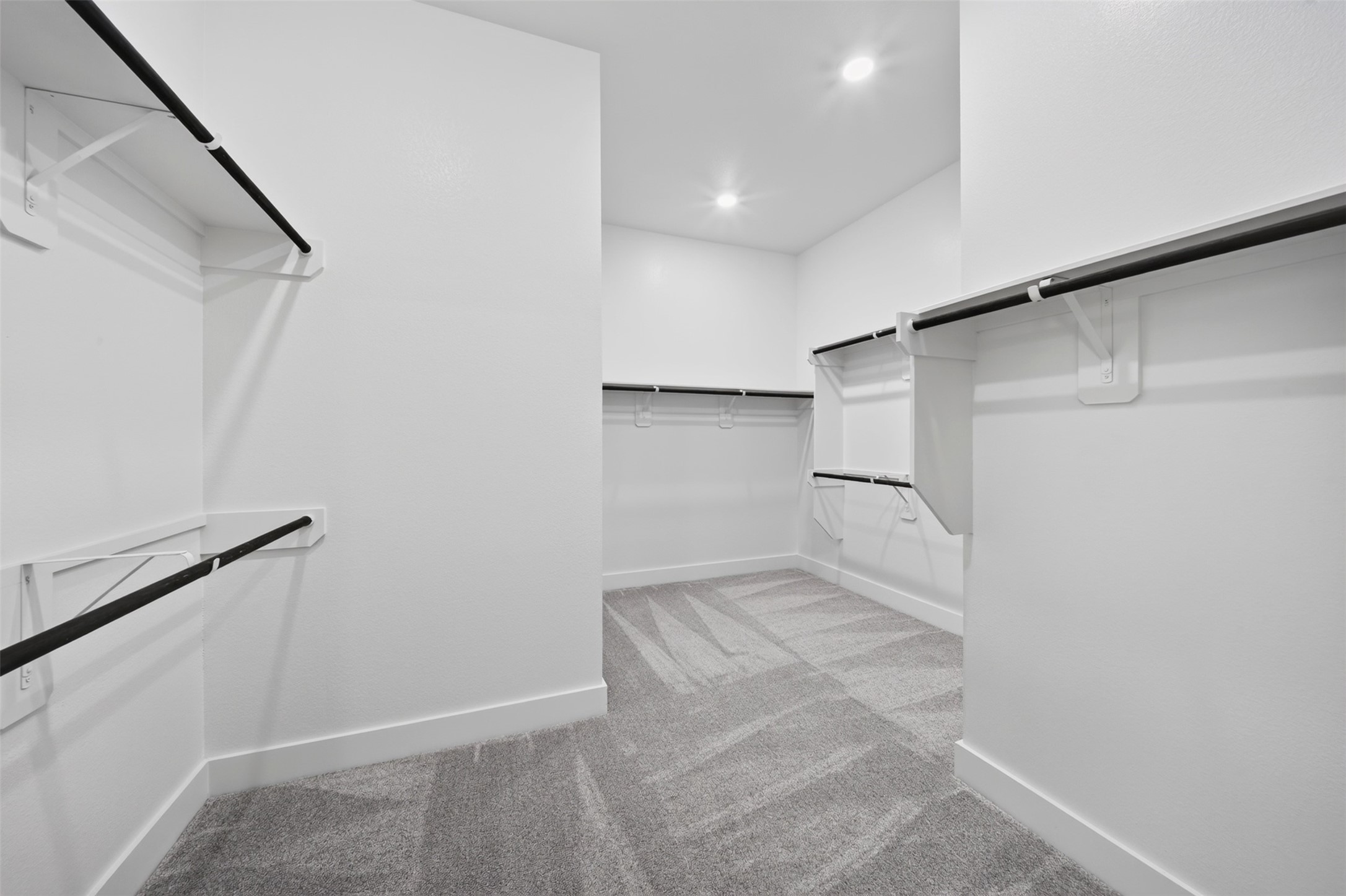 Primary Walk-In Closet: Generously sized primary closet featuring multiple hanging areas, shelving, and an expansive layout for everyday organization.