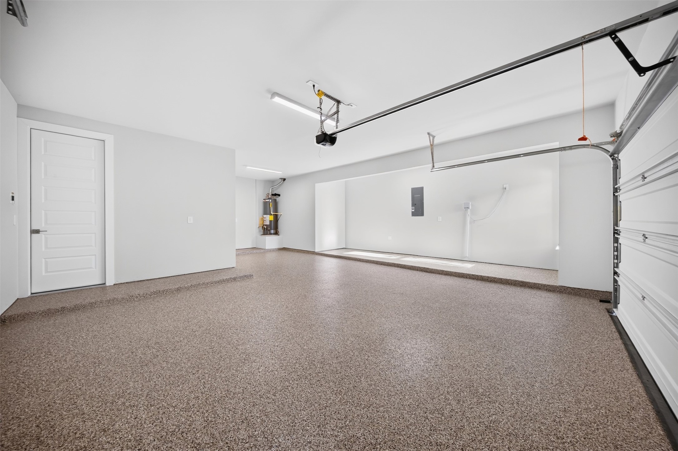 Three-Car Garage  Additional View: Another perspective showcases the generous garage layout, finished flooring, and versatile space for vehicles, equipment, and additional storage.