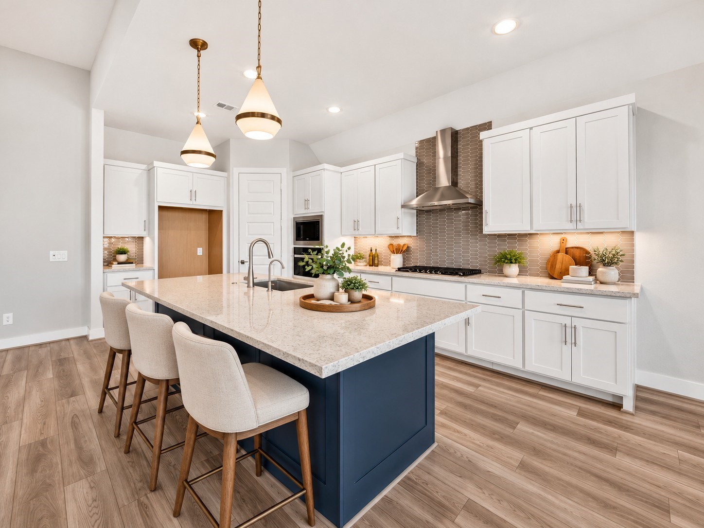 Gourmet Kitchen & Oversized Island: Stunning kitchen featuring an expansive navy island with seating, elegant pendant lighting, gas cooktop, abundant cabinetry, and beautiful contrasting finishesdesigned for effortless entertaining.