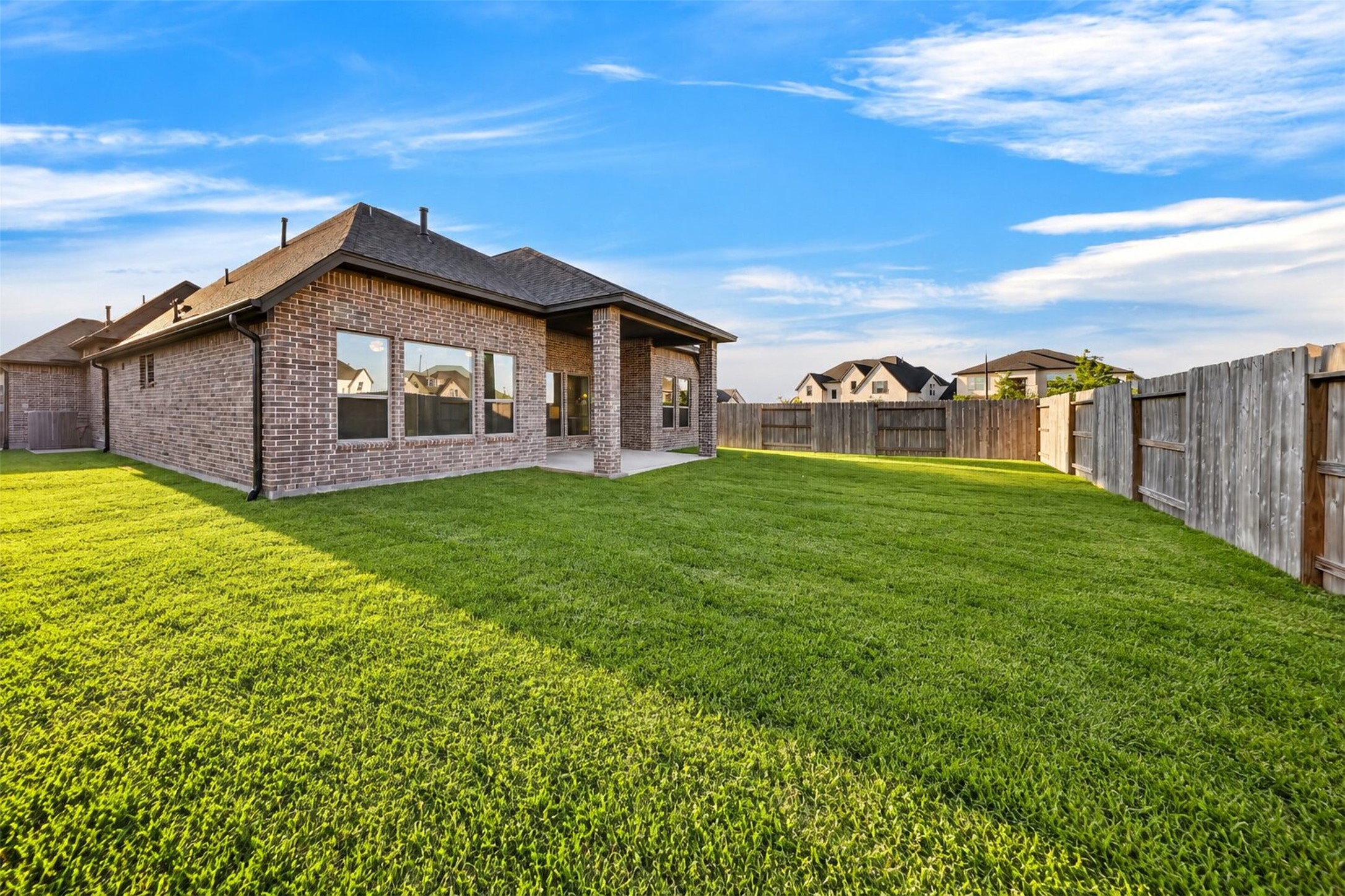 Backyard  Additional View: Expansive backyard showcasing a beautiful lawn, privacy fencing, and an inviting covered patio with plenty of room to relax, entertain, and enjoy the outdoors.