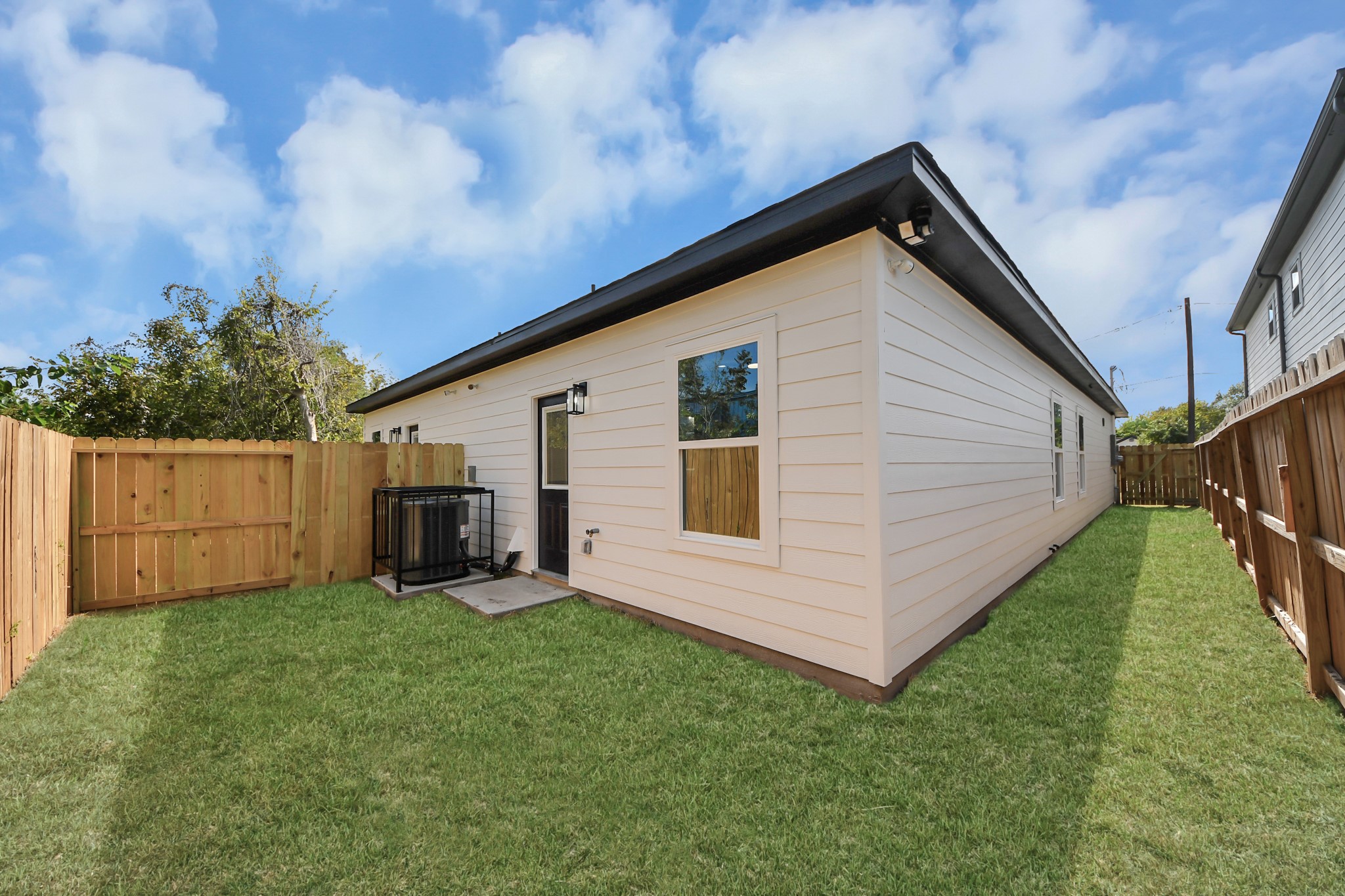 Cozy backyard with well-maintained lawn, privacy fencing, and easy access to the home.