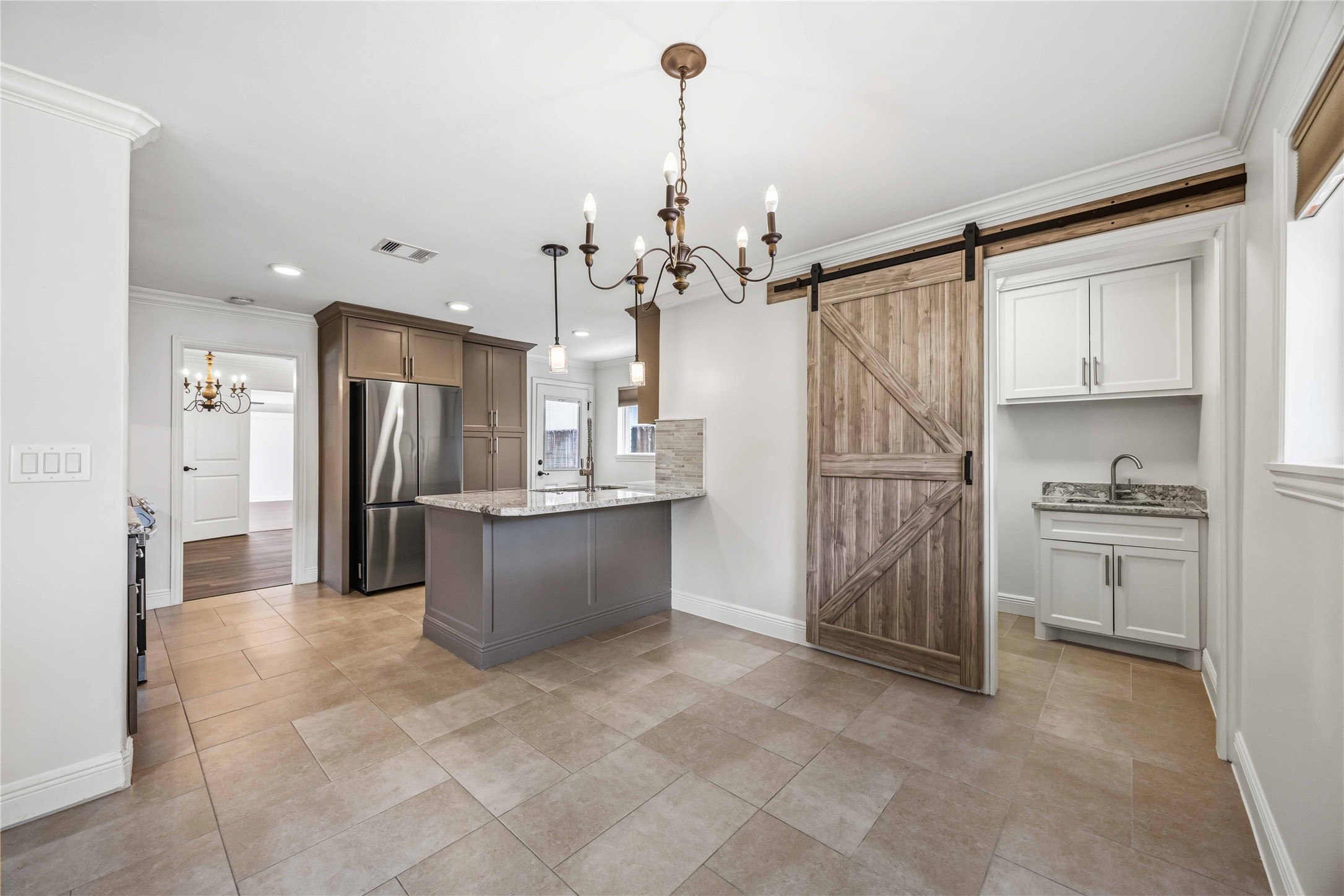 Hidden laundry room w/ barn door off breakfast nook.