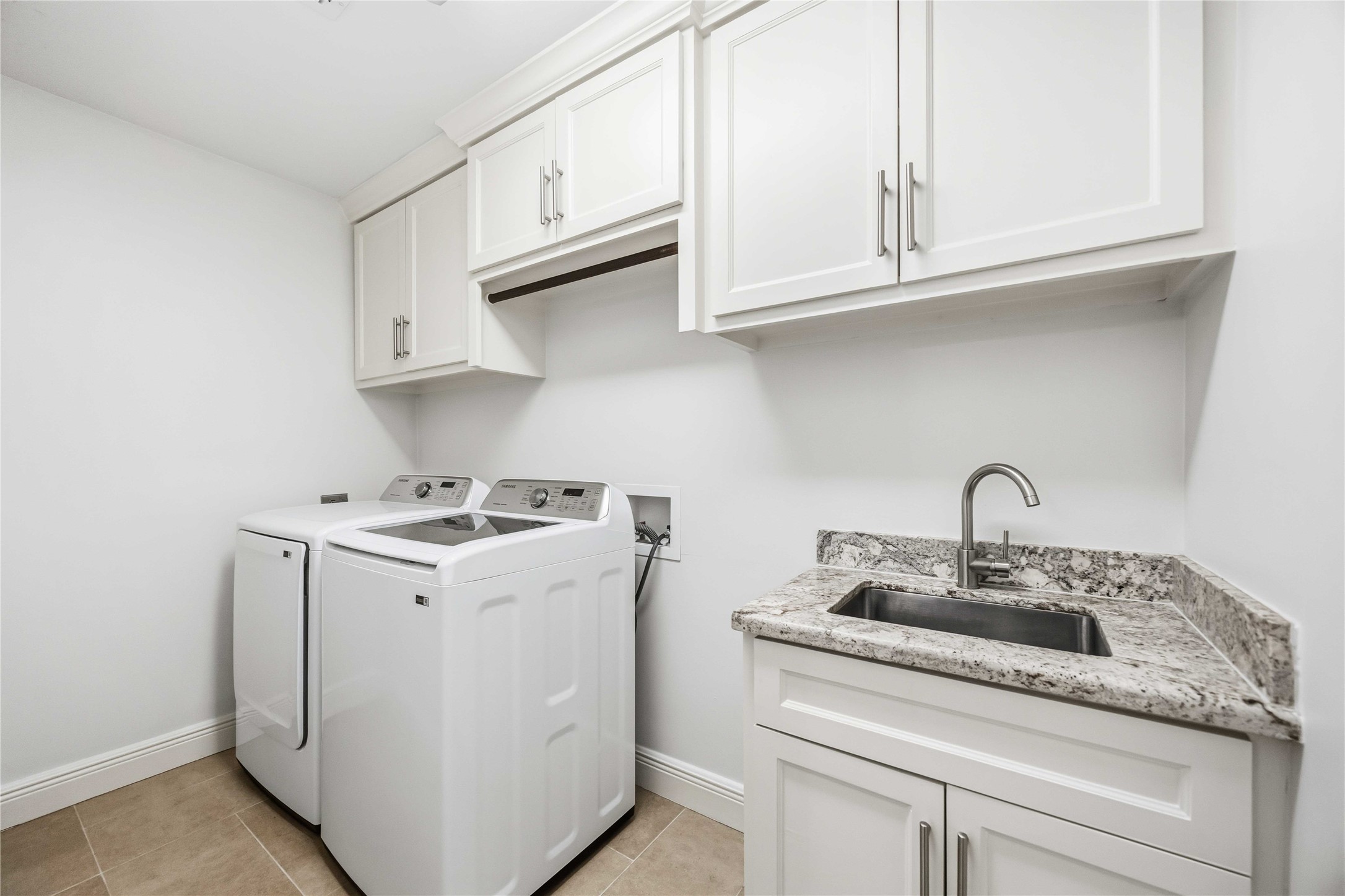 Utility room w/ full sink and cabinets. W & D included!