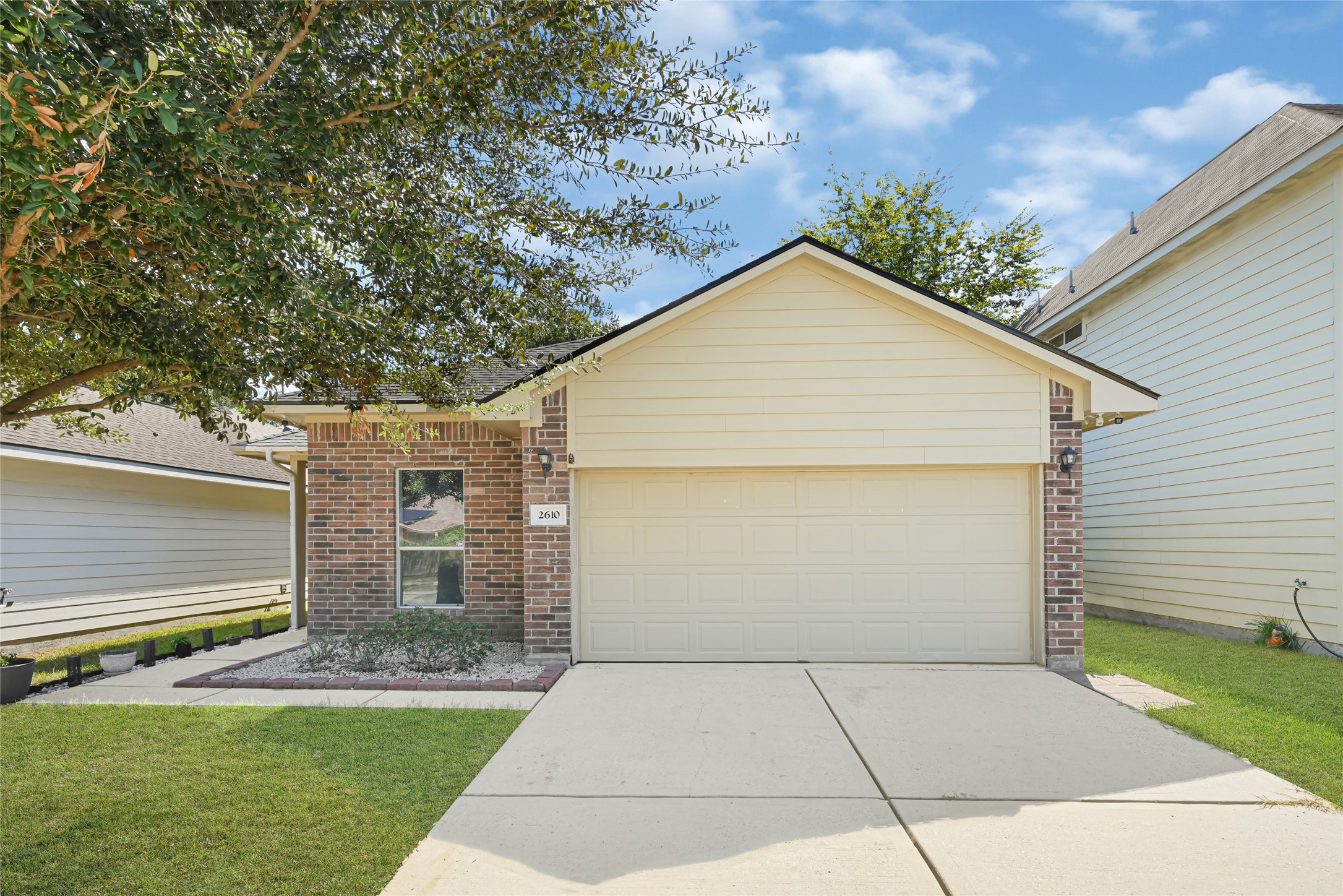 Charming single-story home with a classic brick and siding exterior, complemented by a spacious two-car garage and a neatly manicured front lawn. Charming single-story home with a classic brick and siding exterior, complemented by a spacious two-car garage and a neatly manicured front lawn.