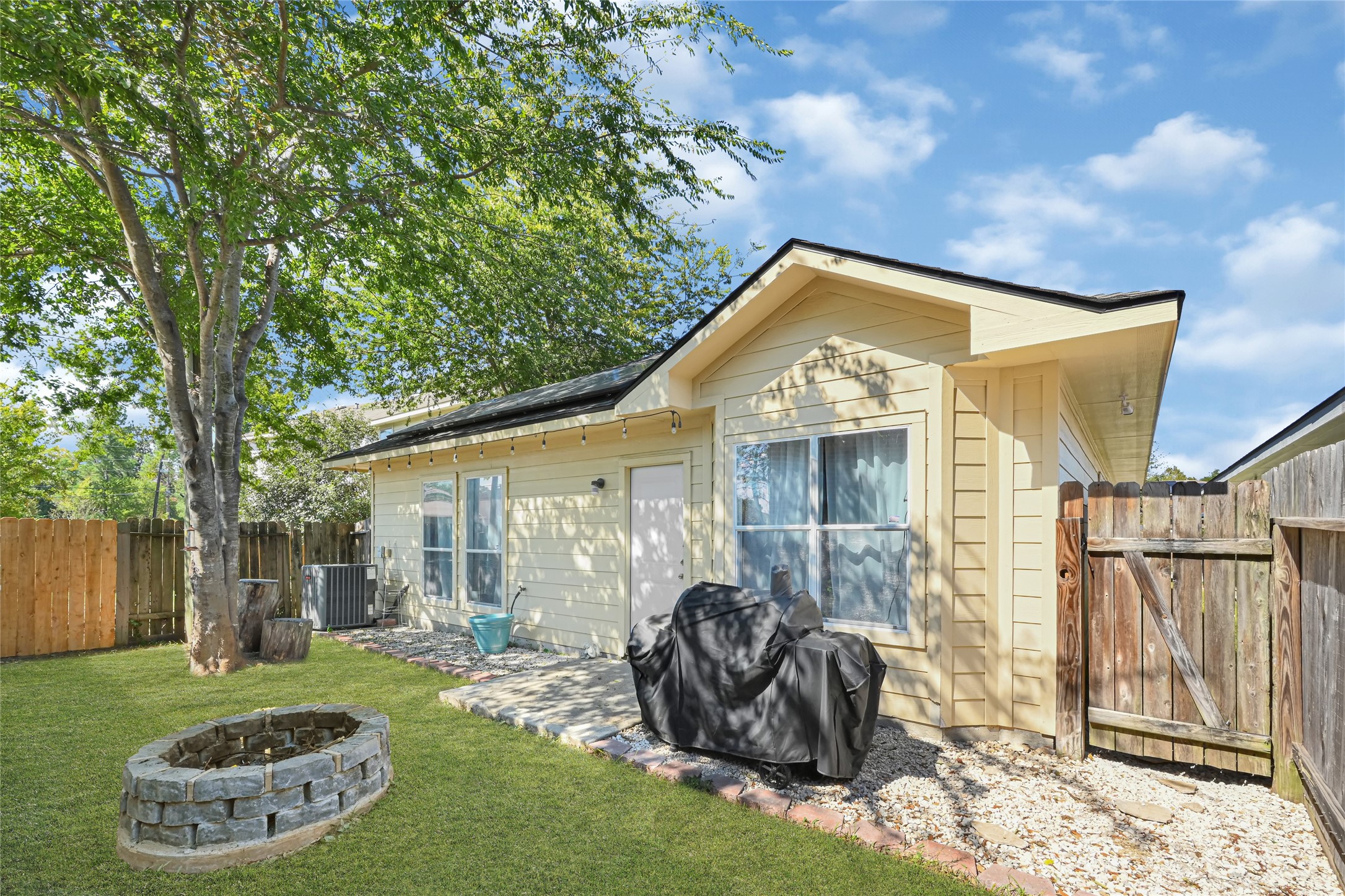 Charming backyard space featuring a cozy fire pit, mature tree, and a well-maintained exterior, perfect for outdoor gatherings. Charming backyard space featuring a cozy fire pit, mature tree, and a well-maintained exterior, perfect for outdoor gatherings.