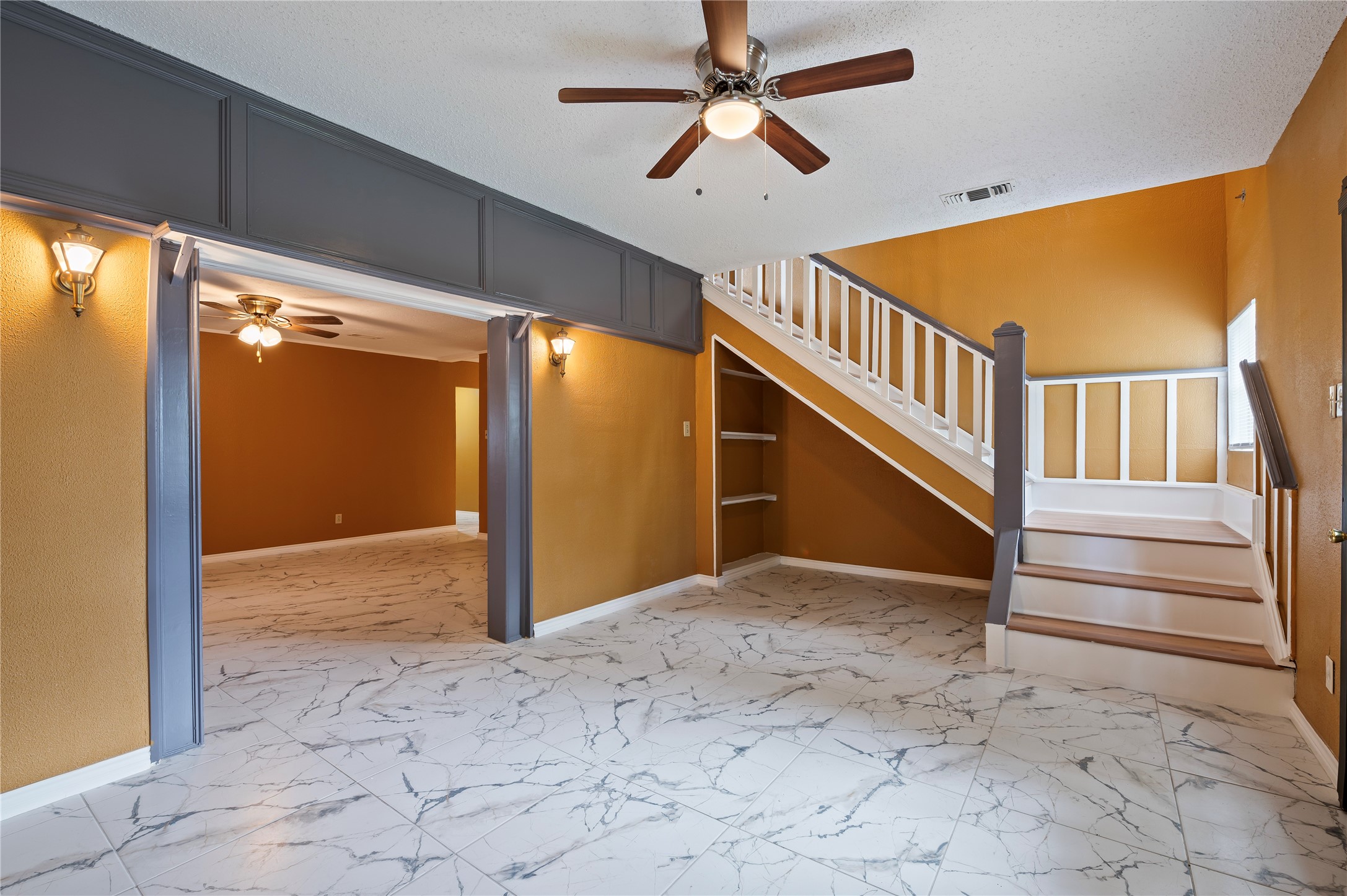 Flex space has stairs leading up to the primary suite.