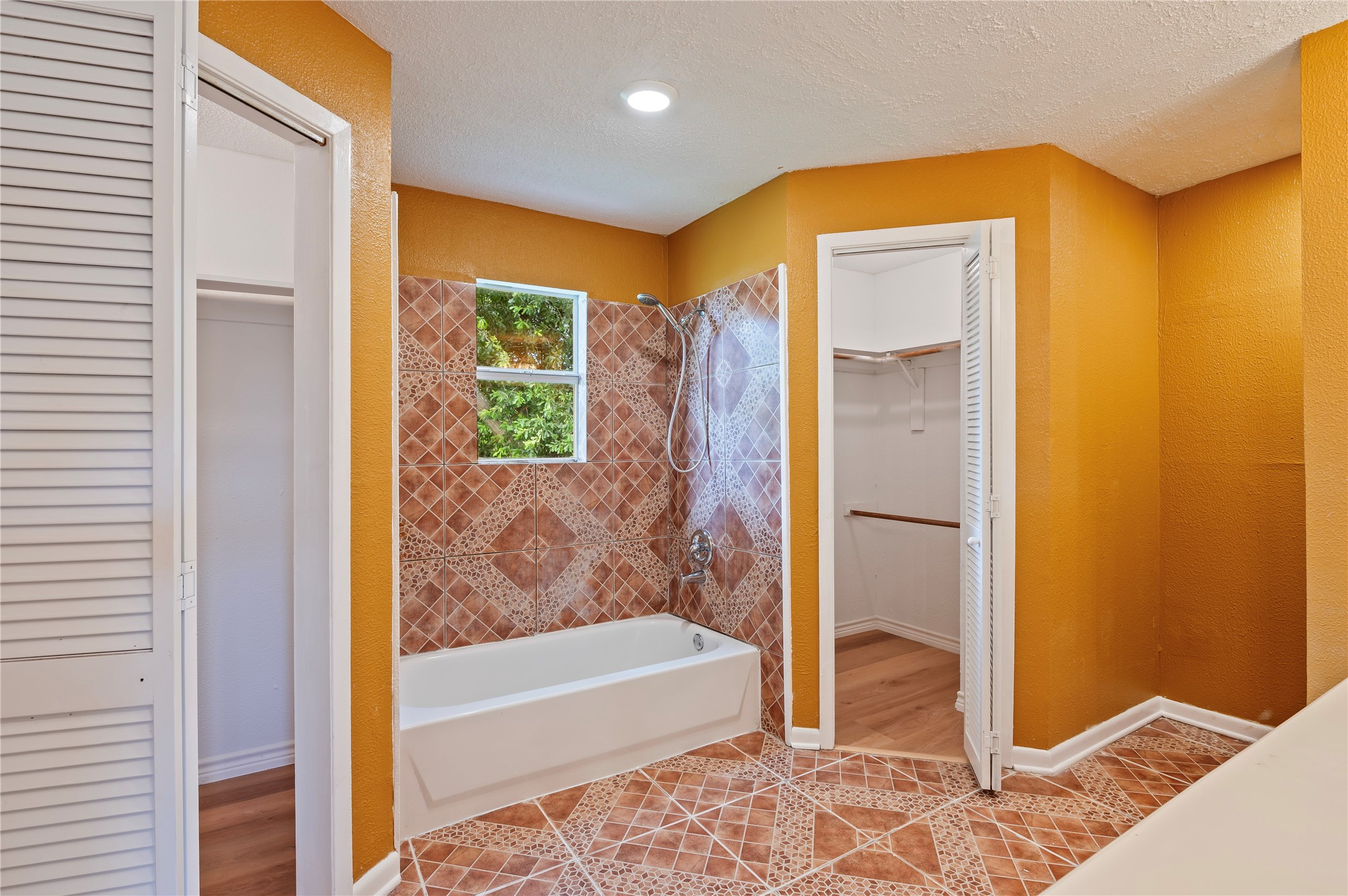 Primary bathroom with two walk-in closets