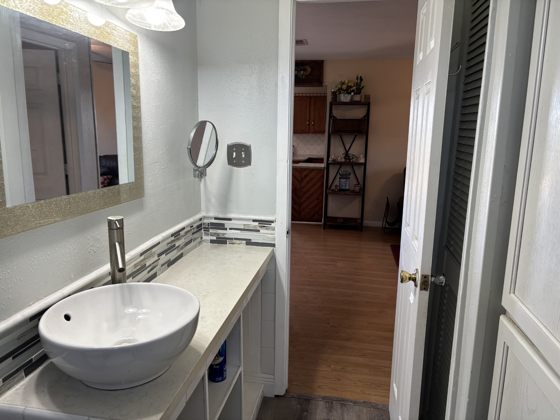 Bathroom ,featuring ranch style sink, large mirrors, and stylish lights