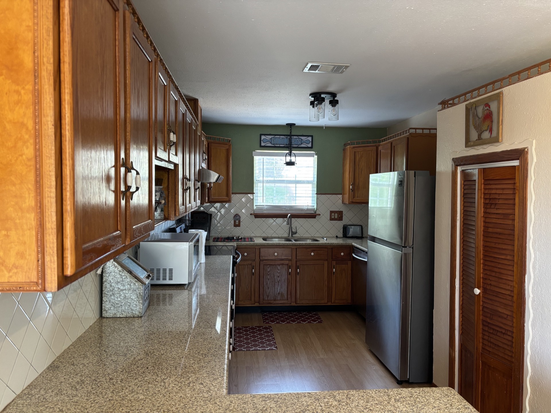 Kithchen with refrigerator, granite countertops, lots of storage with wood cabinets,, and pantry Kithchen with refrigerator, granite countertops, lots of storage with wood cabinets,, and pantry