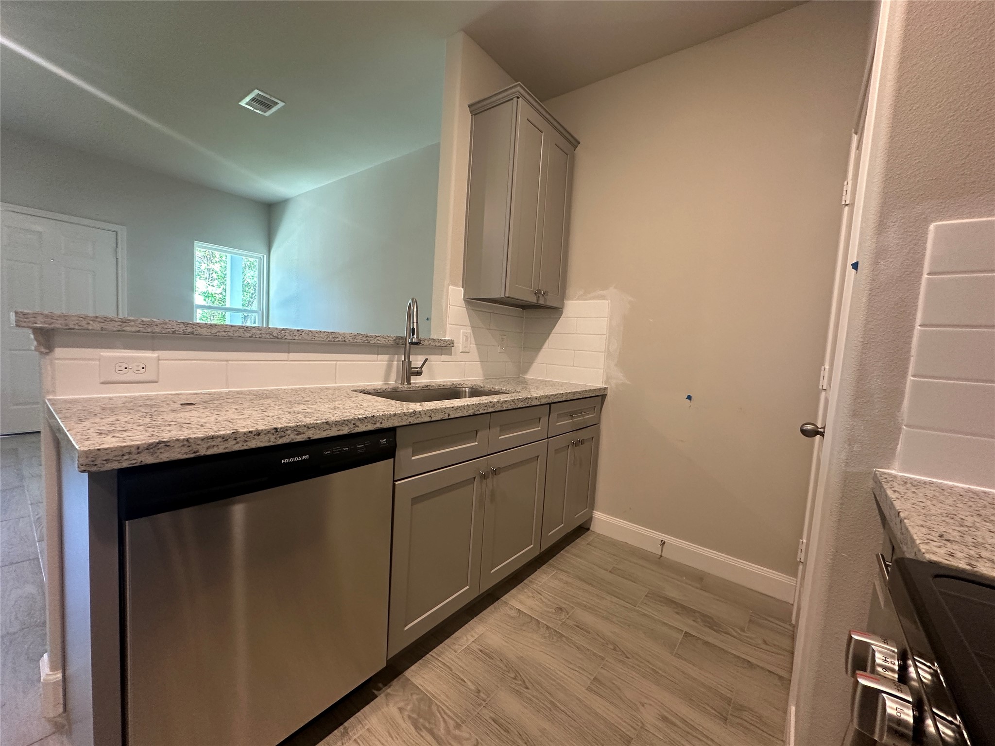 Bright and functional kitchen workspace showcasing premium granite and clean finishes.