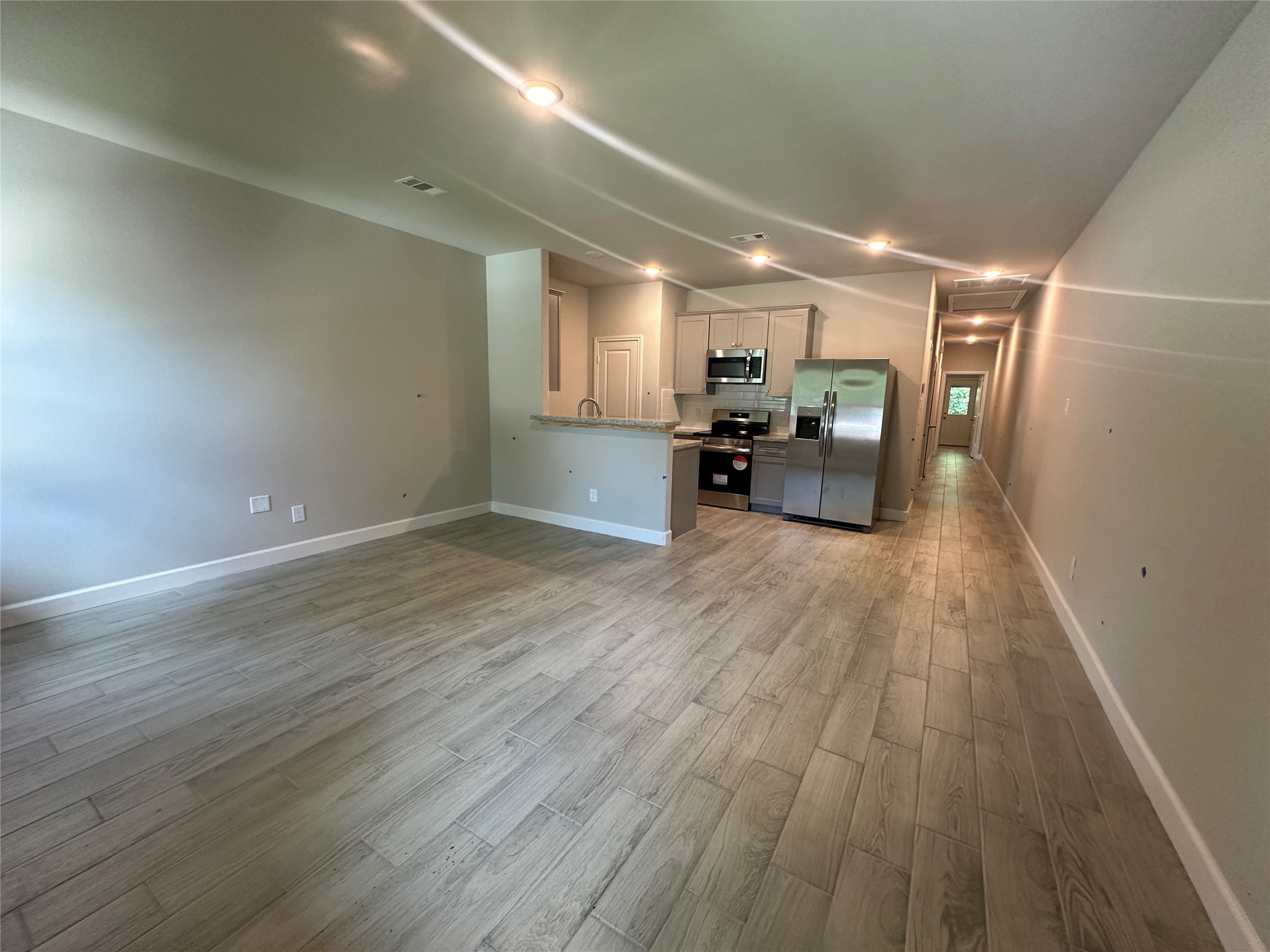 Unit A; large open-concept layout with premium tile flooring.