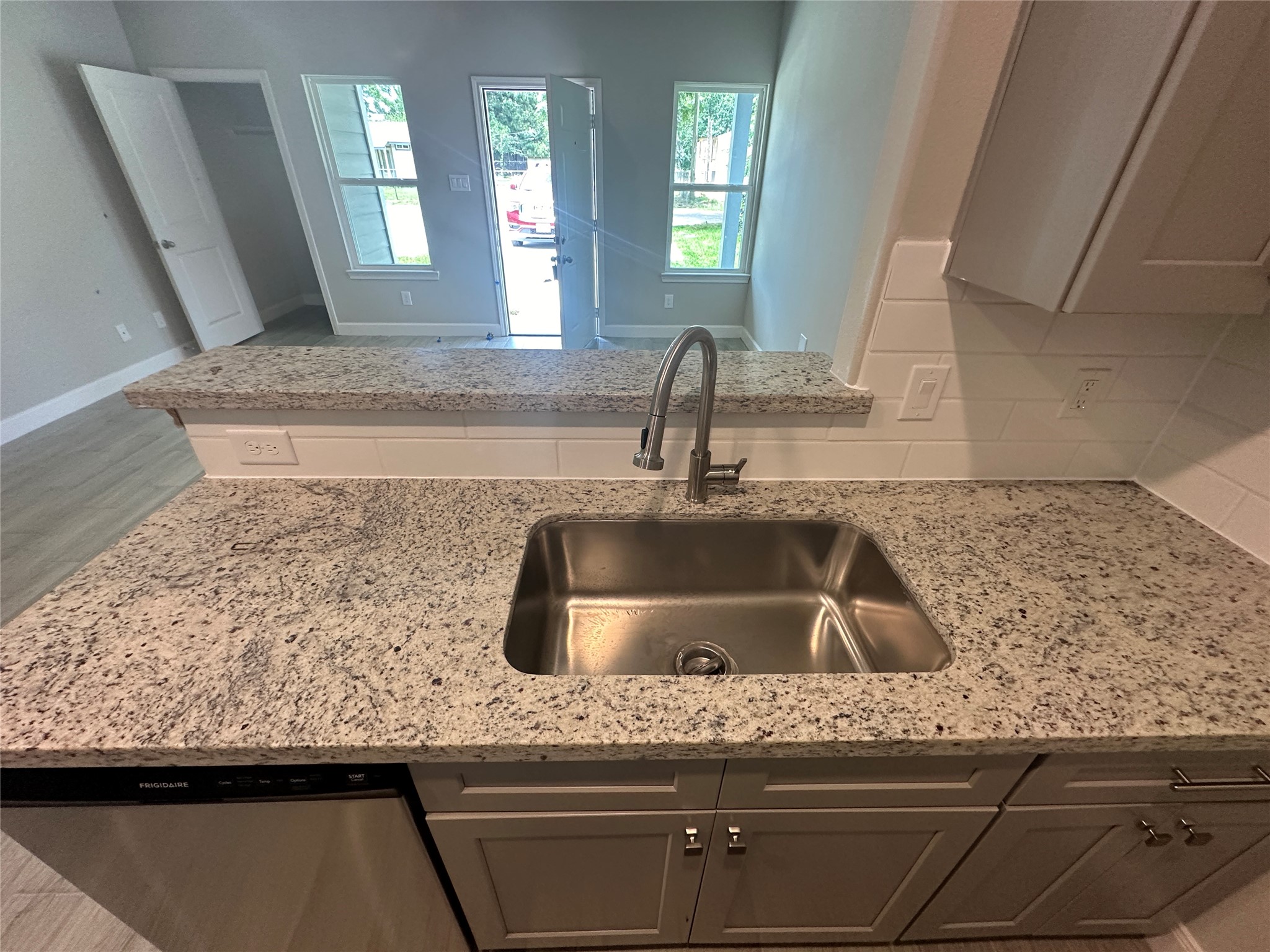 Sleek granite countertops paired with an undermount stainless steel sink and modern fixtures.