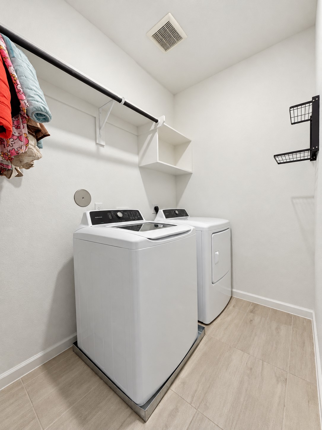 15. Upstairs laundry room with overhead shelving.