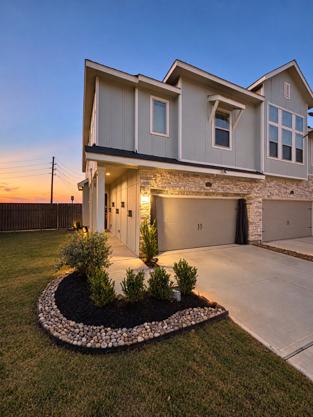 1. Contemporary two-story exterior with stone accents and an attached two-car garage.