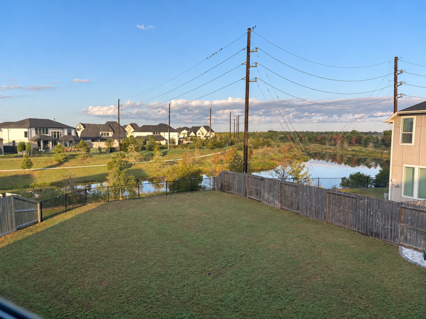 2. Spacious fenced backyard with lake views on a 7,106-square-foot lot. 2. Spacious fenced backyard with lake views on a 7,106-square-foot lot.