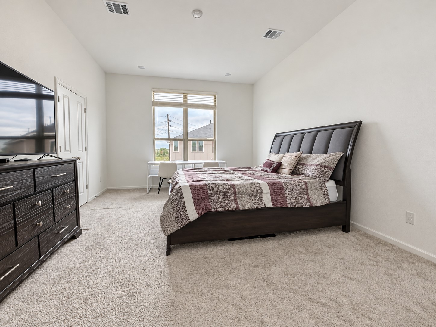 8. Primary bedroom with natural light and space for a king-size bed.