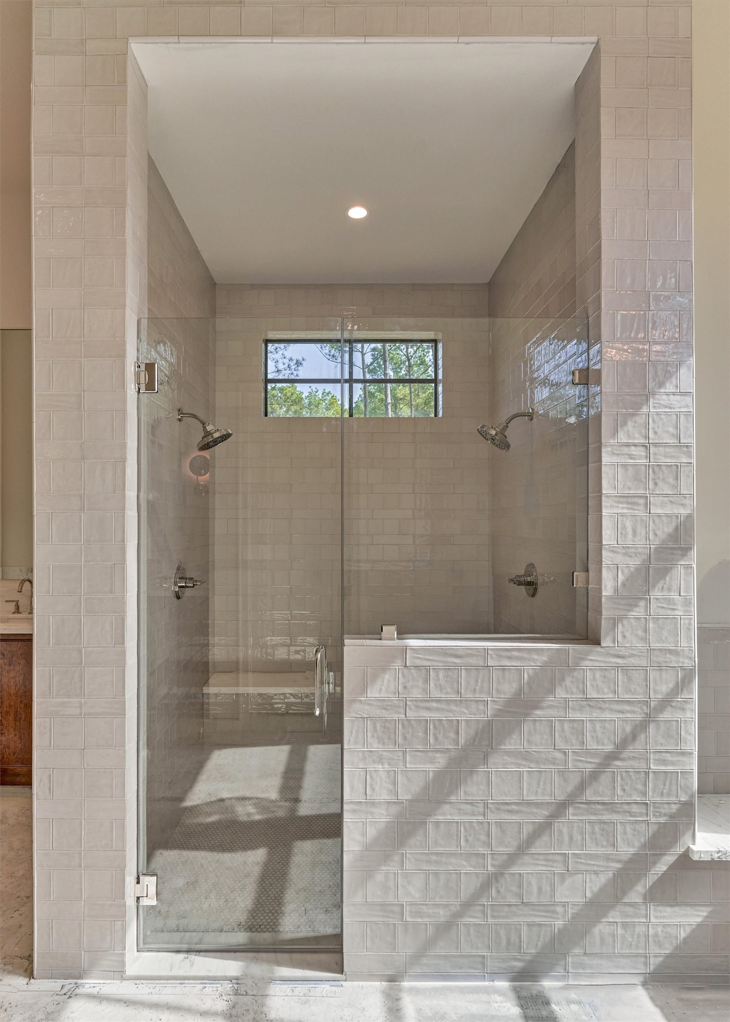An abundance of natural light enhances the timeless elegance of this primary bath.