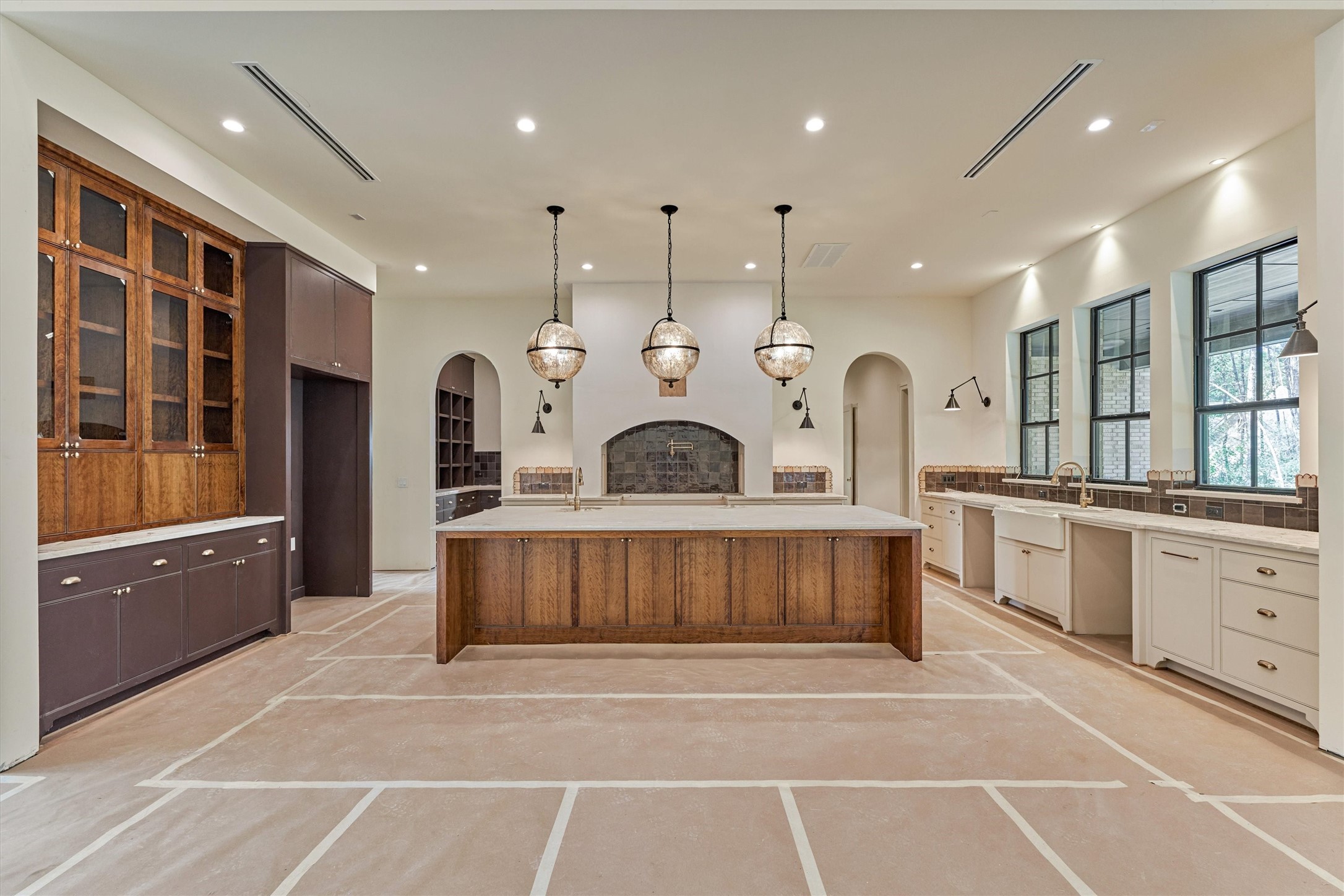 Expansive custom cabinetry, large island with bar seating that tucks neatly underneath for clean, open flow and well appointed layout.  Instant hot water tap added for convenience.