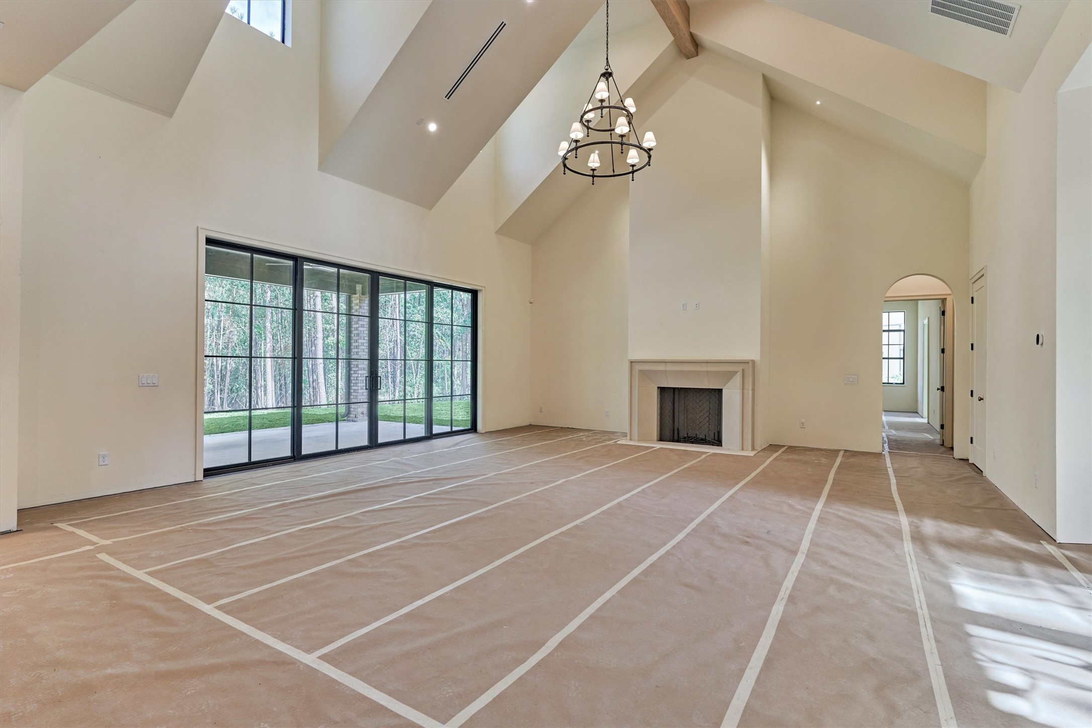 Construction progress highlighting the main living area, showcasing floor-to-ceiling fireplace that defines the space with architectural elegance.