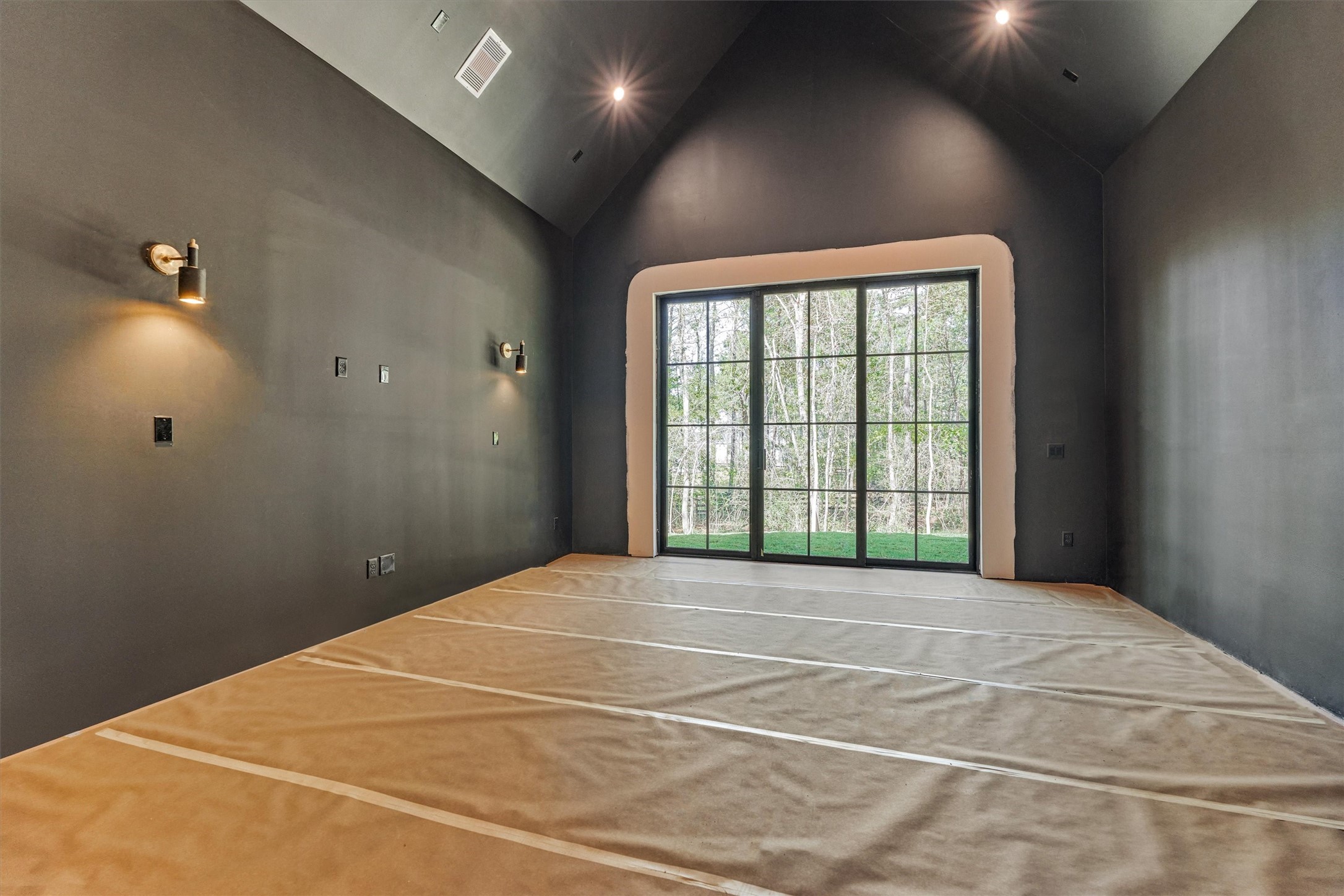 An expansive game room designed for elevated entertainment, complemented by beautiful views of the backyard.