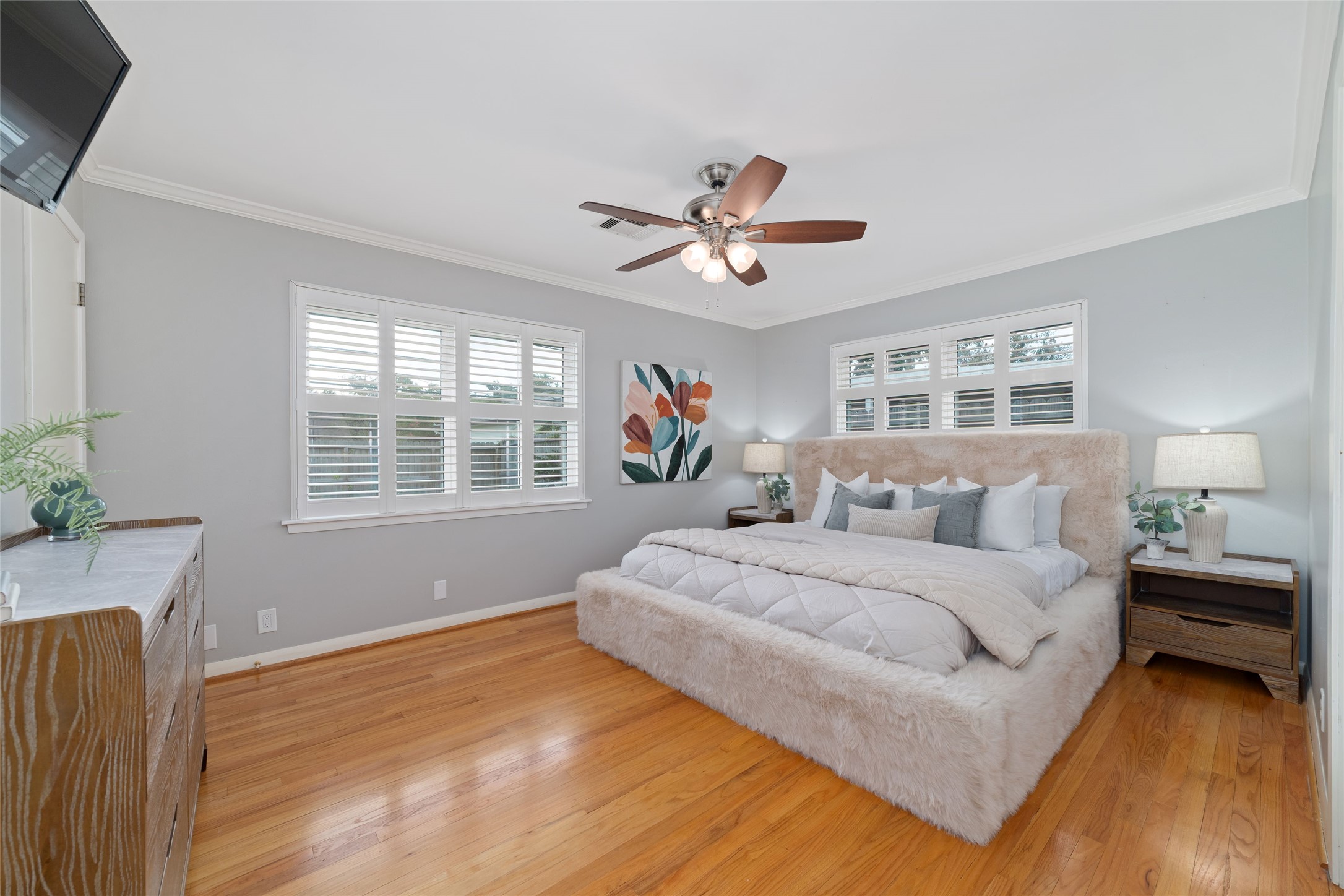 Spacious primary suite offers two walk in closets and a remodeled en suite bath