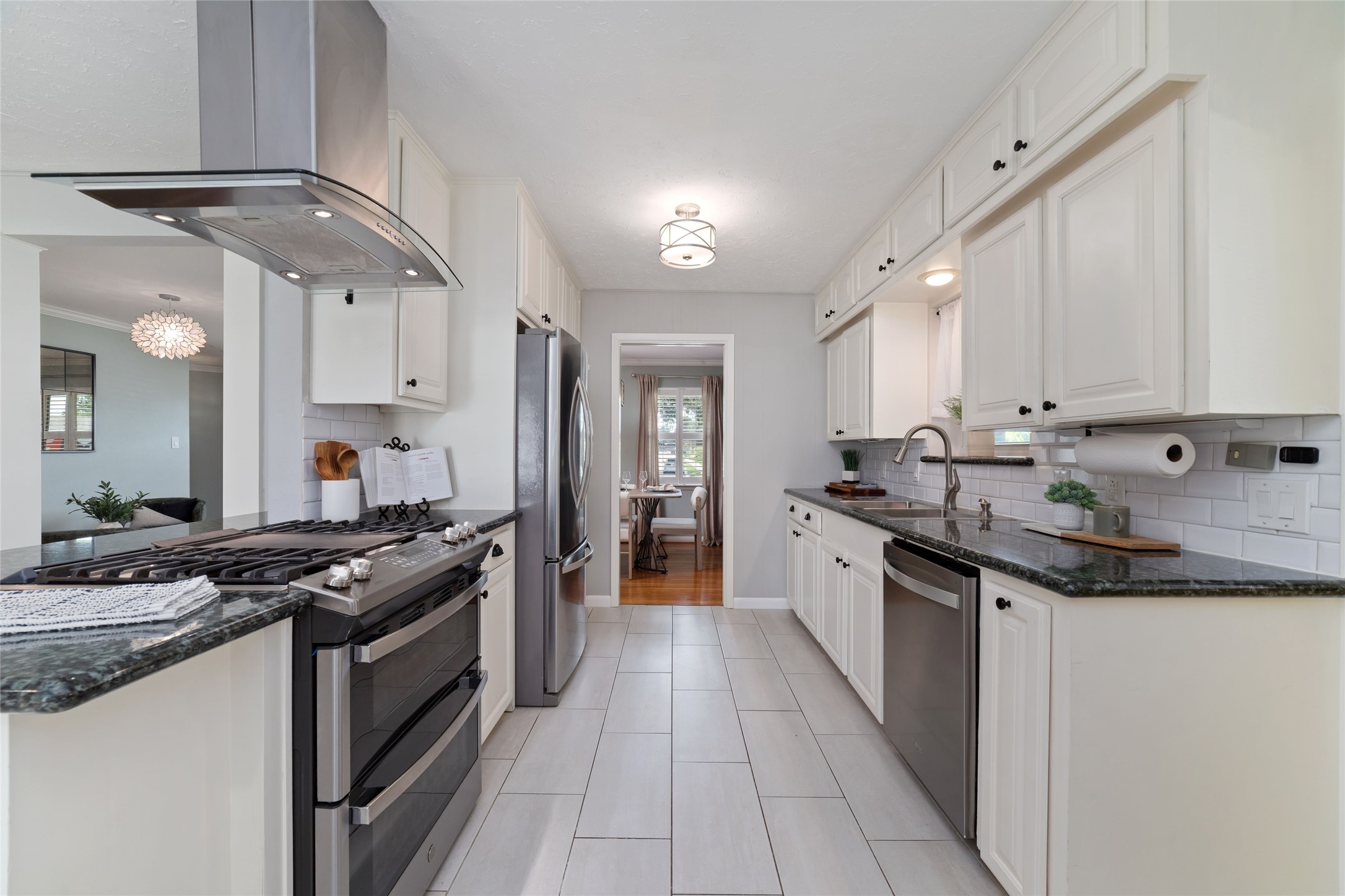 Kitchen offers ample cabinet space, granite countertops and stainless steel appliances.