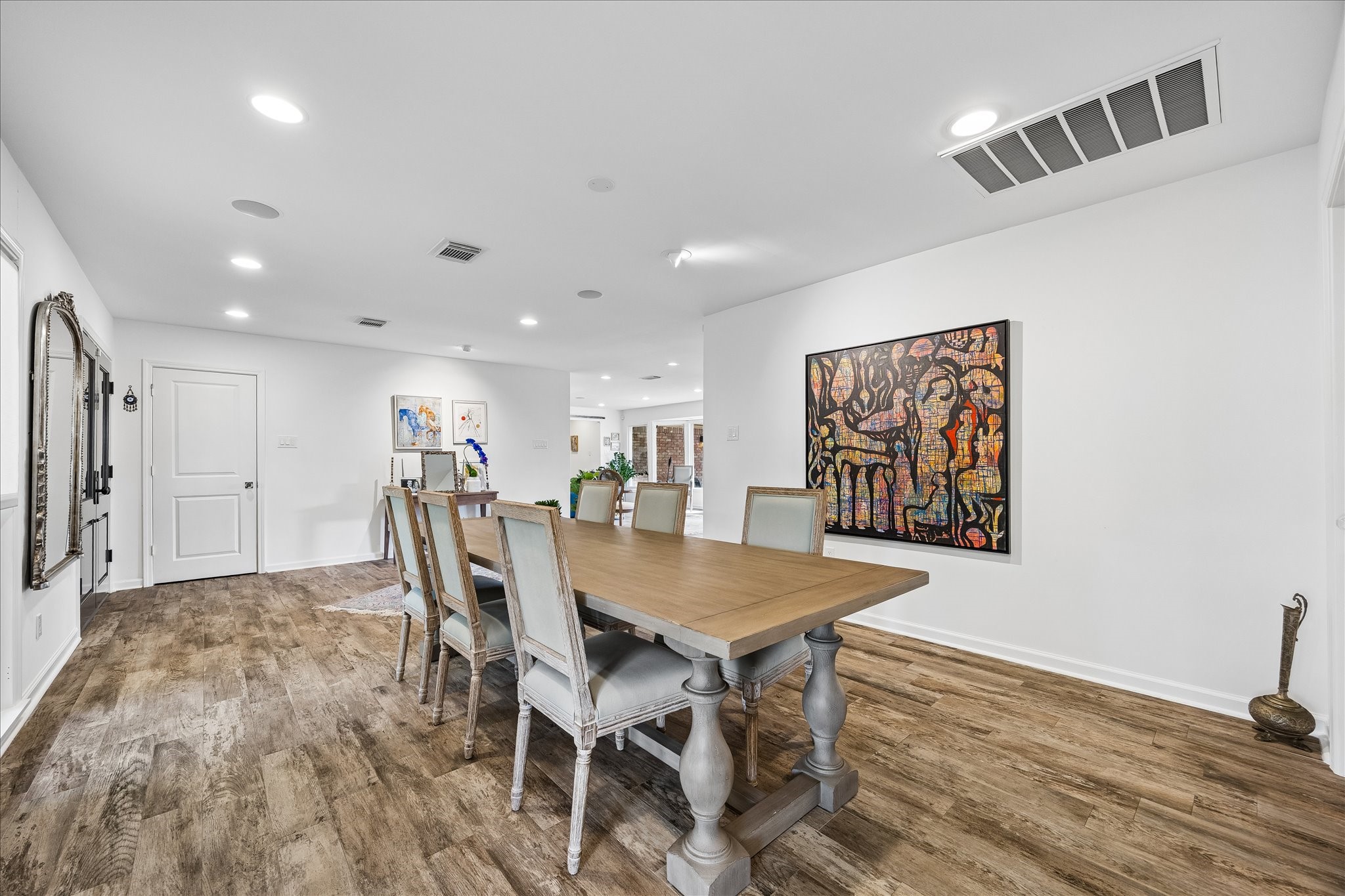 Dining area offers wonderful space for hosting gatherings, w/an open layout connecting to the kitchen & living areas. Neutral walls, recessed lighting & continuous wood-look flooring create a seamless flow throughout.