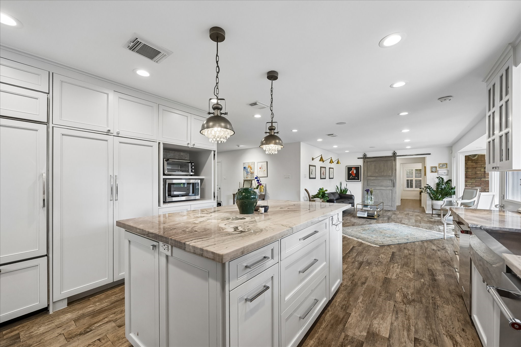 Kitchen offers exceptional storage w/floor-to-ceiling cabinetry, built-in appliances, spacious island w/additional drawers & recessed lighting. The open design connects effortlessly to the living area, creating a wonderful space for everyday living.