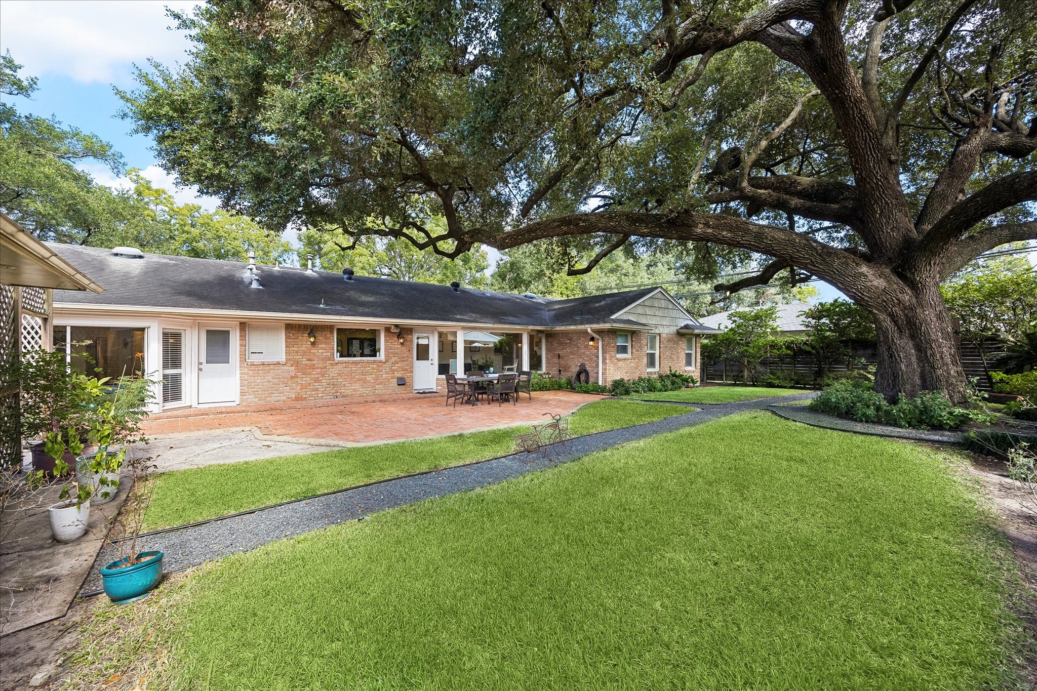 Expansive backyard offers a beautiful setting w/lush green lawn, mature tree, colorful landscaping & winding gravel pathways. Large brick patio provides wonderful space for outdoor dining, entertaining & enjoying the peaceful surroundings.