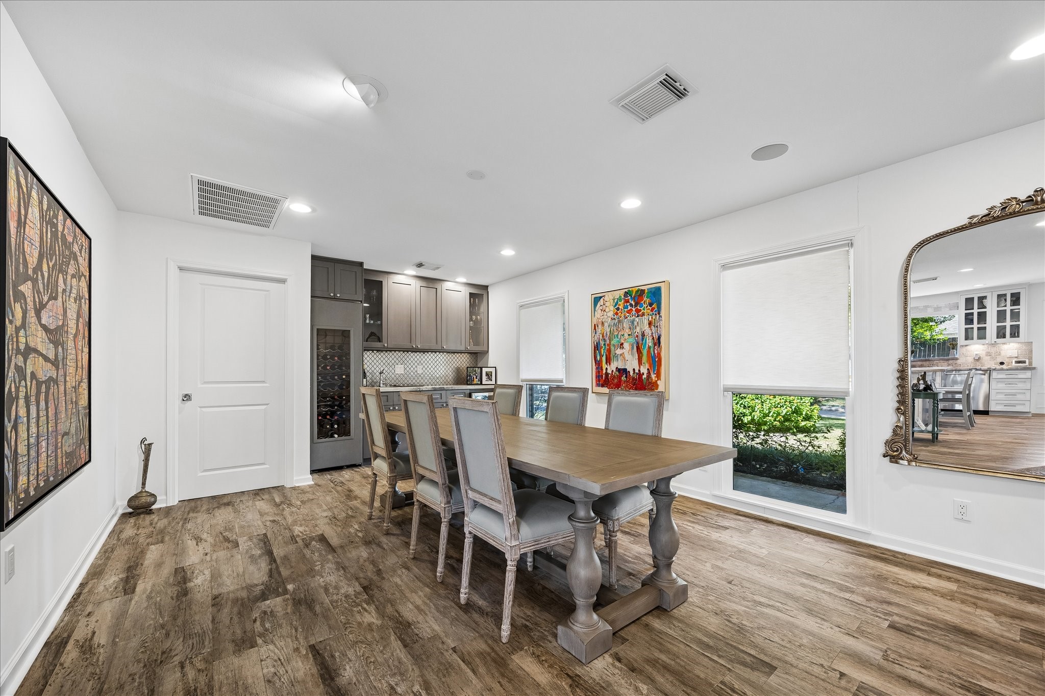 Spacious dining area features wood flooring, recessed lighting & large windows overlooking the front lawn. Built-in cabinetry w/wine storage, beverage refrigerator & gorgeous tile backsplash and countertop provides a convenient serving area for entertaining.